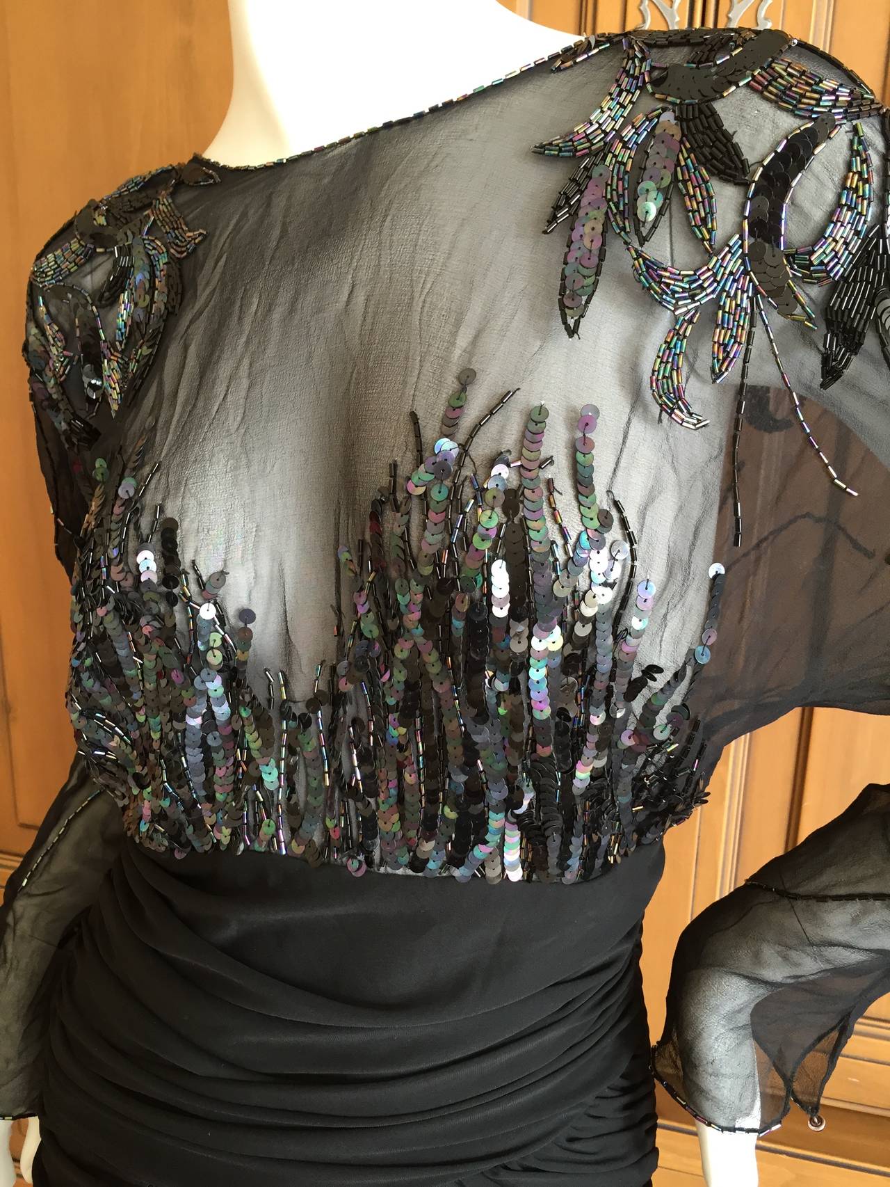 Bob Mackie Sexy Disco Era Sheer Sequin Little Black Dress from Saks Fifth Avenue Circa 1978
This is amazing, very daring.
The skirt is a beautiful draped black jersey, the top is sheer, beaded as only Mackie can.
No size tag this is a small size
