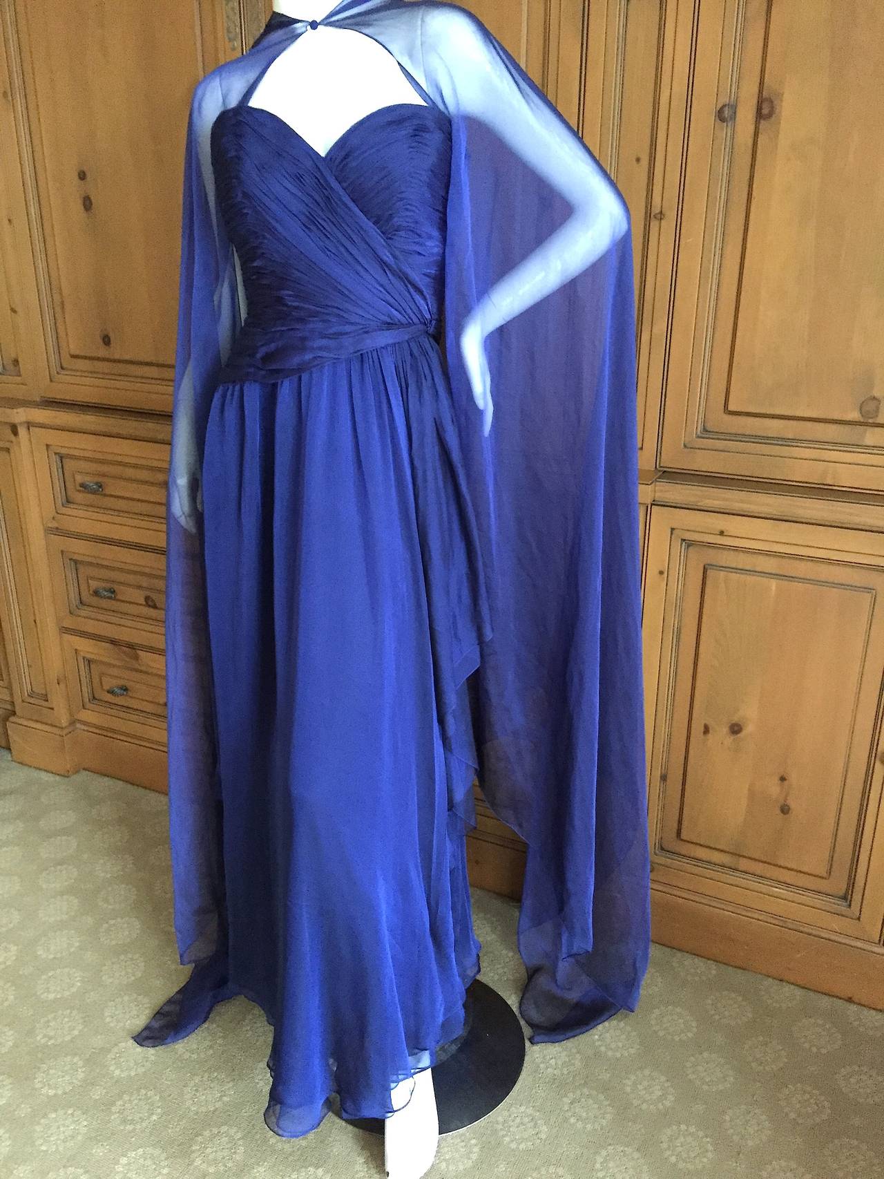 Beautiful irridescent midnight blue silk chiffon ruched strapless dress with matching cape, from Oscar de la Renta for Amen Wardy circa 1980.
This is such a pretty piece, the photos don't quite capture its charms.
Featuring a full interior corset,