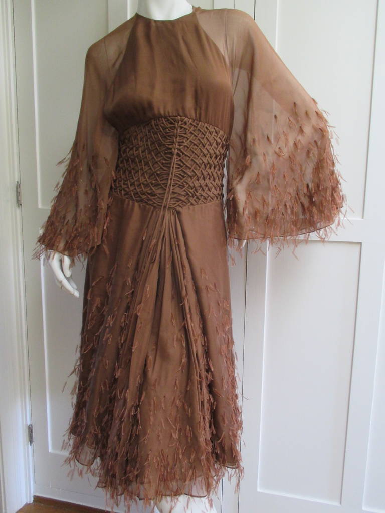 Ralph Rucci Sublime Silk Feather Backless Dress.
This is one of the prettiest Ralph Rucci dresses I've ever seen.
Silk chiffon with bell sleeves, and miles of silk in the skirt.
Ostrich feathers have been hand attached all over.
Knot detailing
