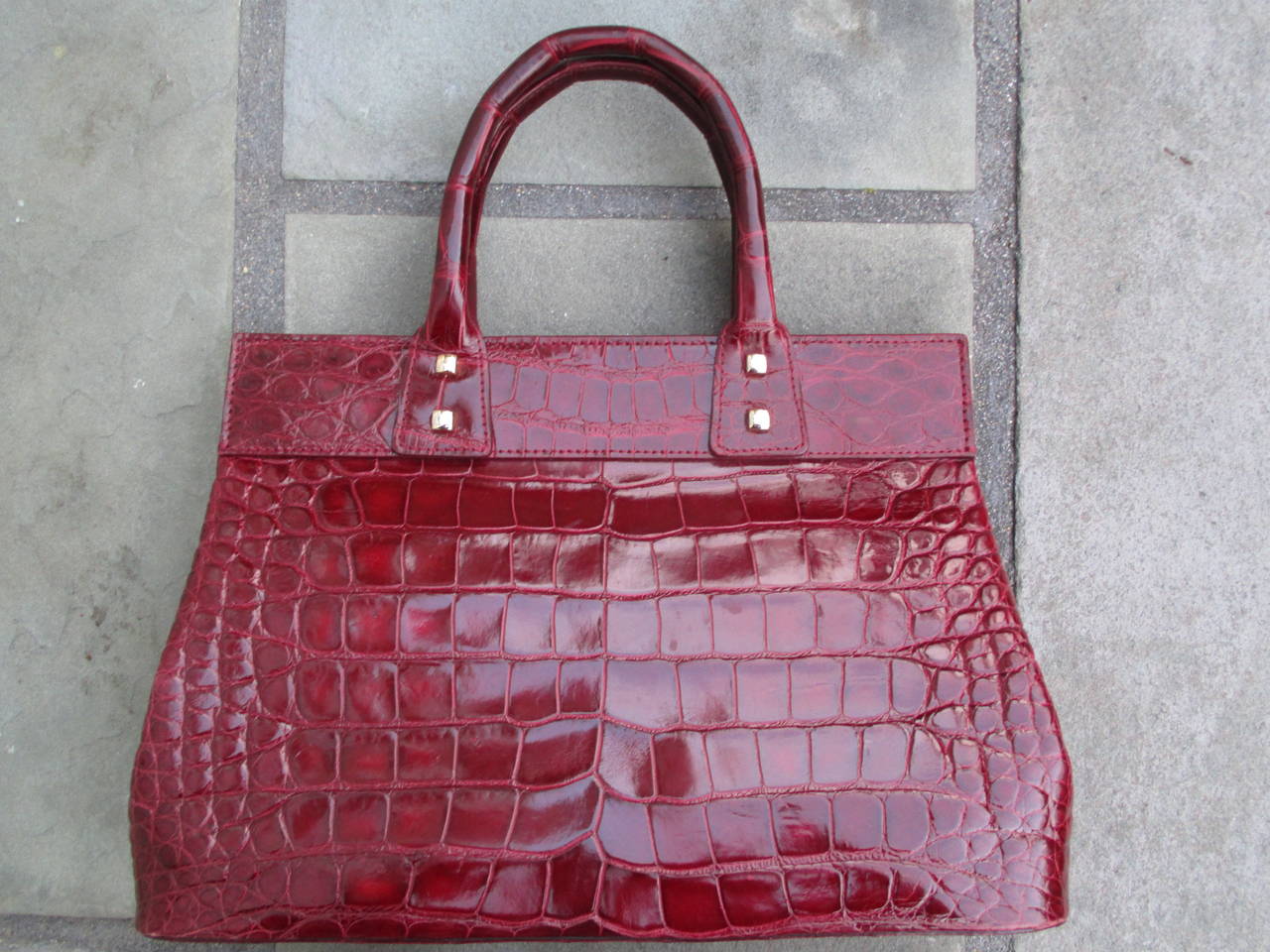 Donna Karan Rouge  Alligator / Crocodile Lock Tote.
This is an exquisite bag. All the press for this piece called it Crocodile.
The stamp and tag read alligator.
$4995 retail