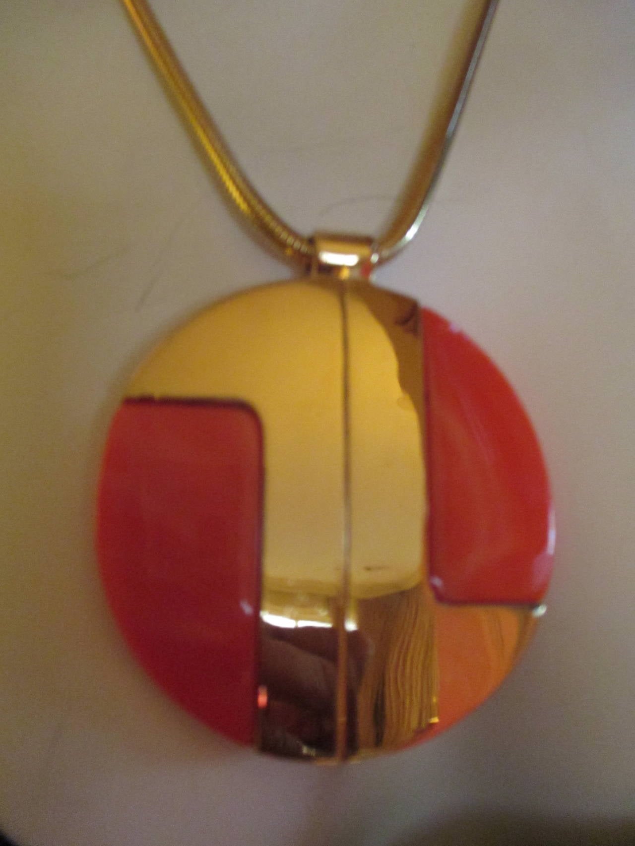 Wonderful bold vintage disc necklace with red on gold.
Snake chain measures 18'
Disc is just under 3