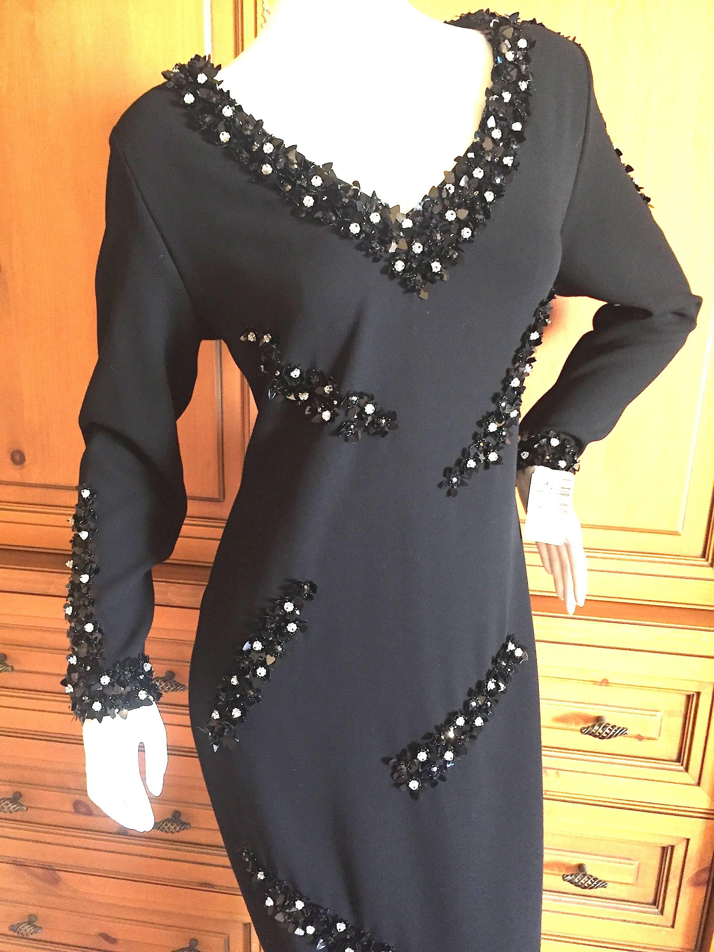 Beautiful black evening dress from James Galanos with black sequins and Swarovski crystal accents through out.
Back zipper, lined in silk.
Size 10
Bust 40