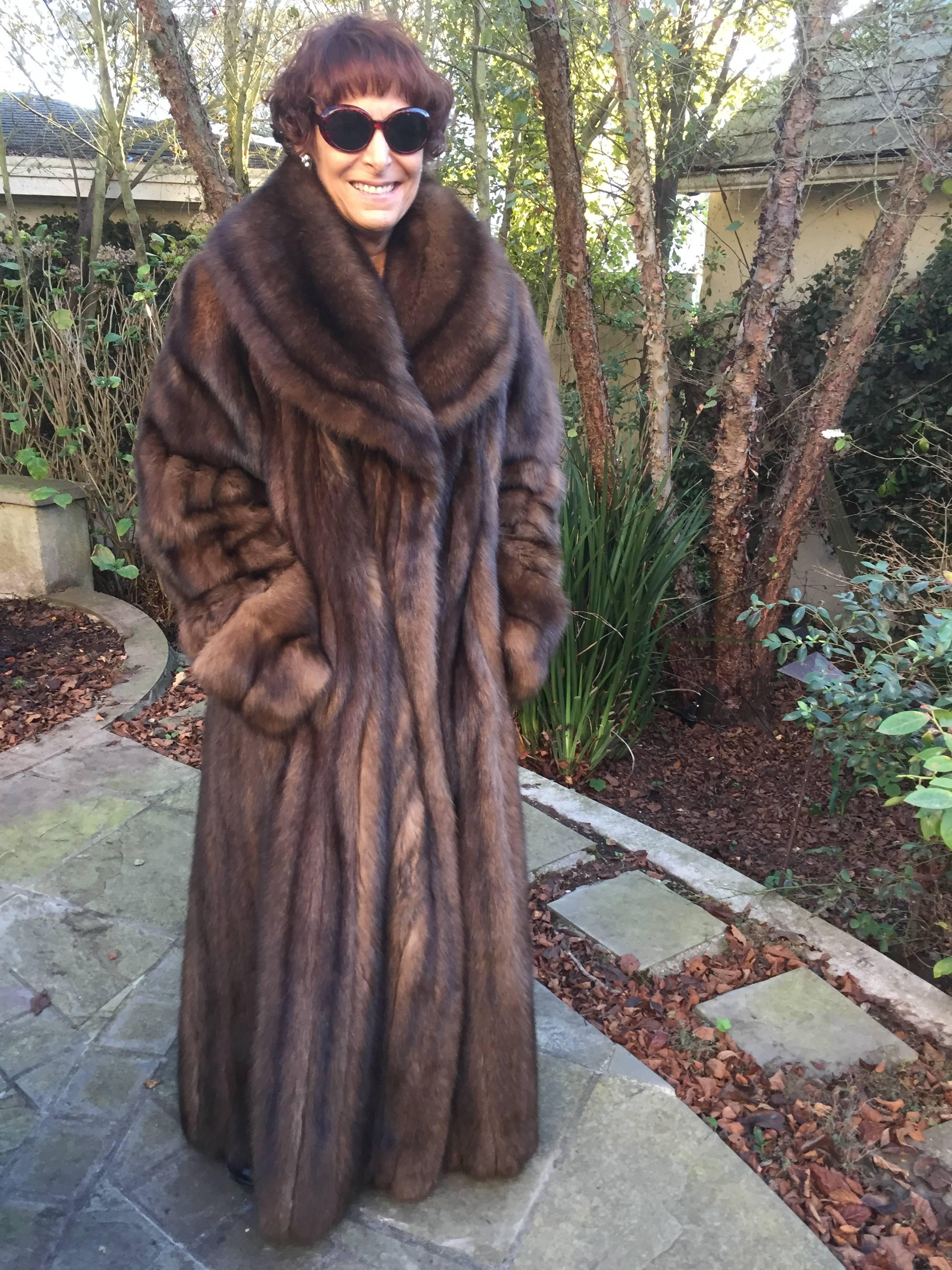 Luxurious floor length Russian Sable coat from the fur department at Neiman Marcus.
Hard to find larger size, this sweeps the floor and is incredibly soft and luxurious.
Would fit a man, see last photo. Model 5' 7