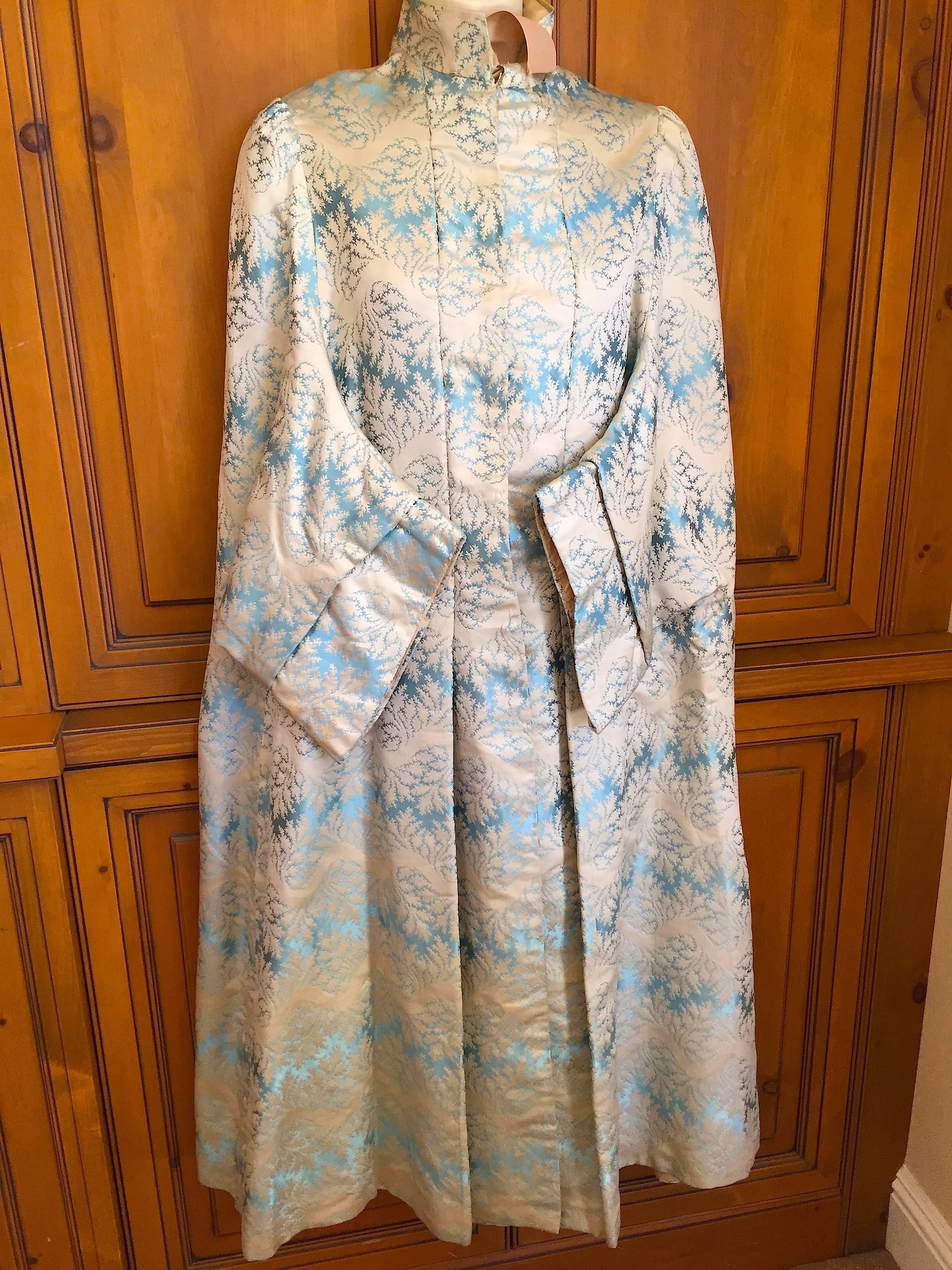 Superb late 19th century outing cloak.
Haute Couture craftsmanship , this is exquisitely made.
Light blue brocade with a wave pattern, the sleeves are kimono style, popular at the time.
The back features inverted pleating to accomodate the large