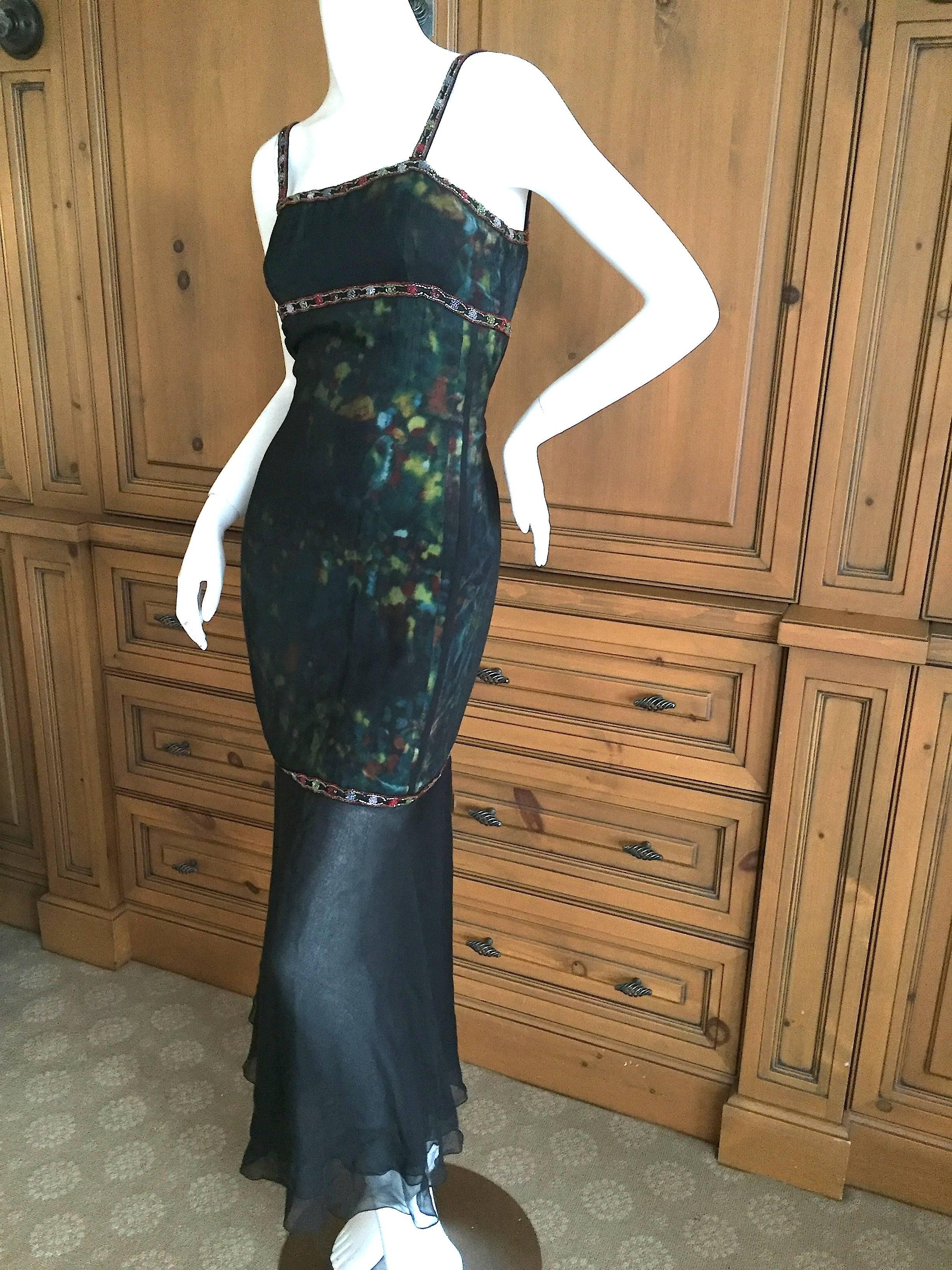 Darkly romantic silk overlay dress with beaded embellishments from Chanel.
There is a digital print underneath the sheer silk, with Lesage beading on strips across the dress. Much prettier in person.
From Autumn 1997
Size 38
Bust 35