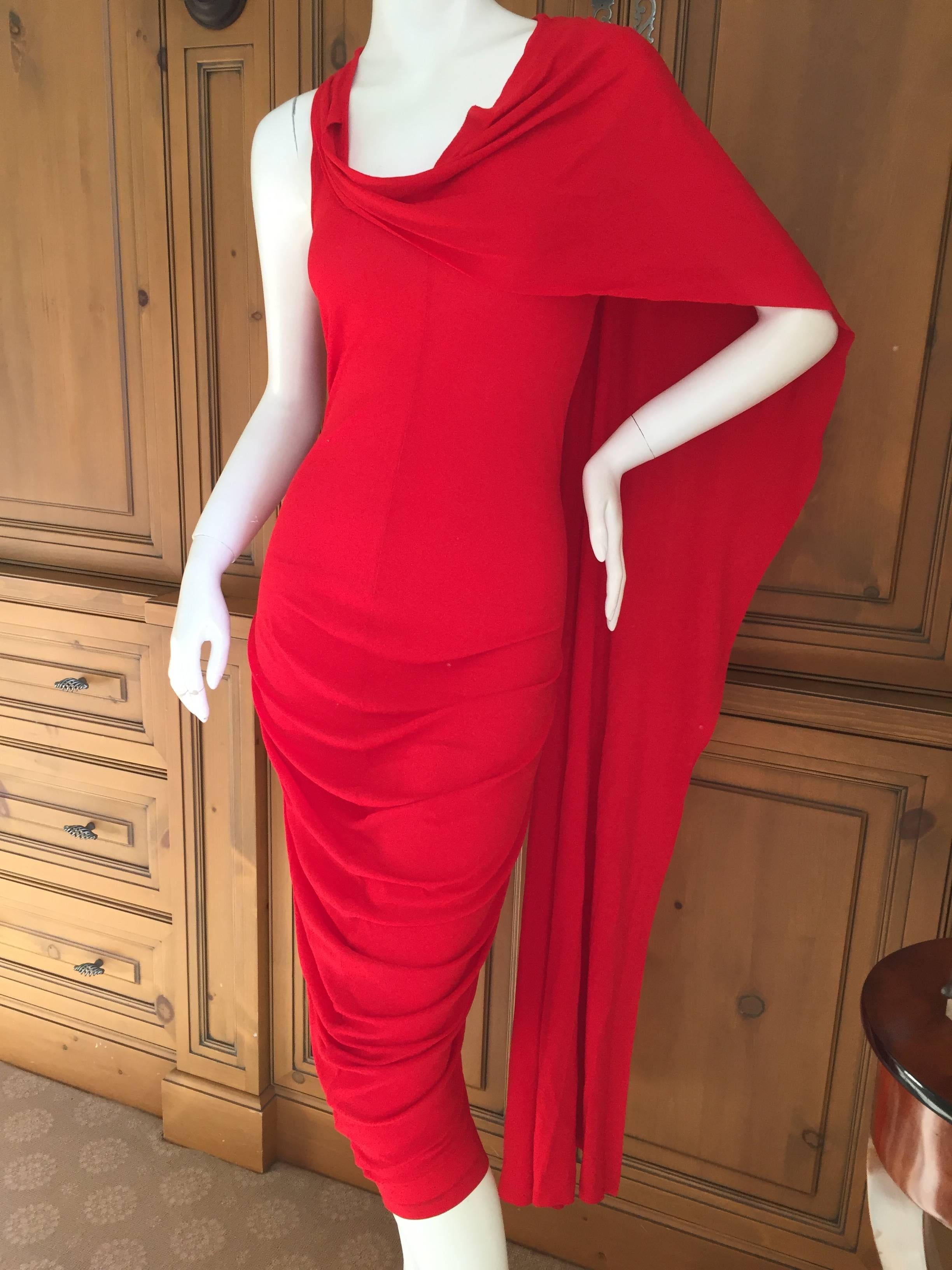 Alexander McQueen red jersey dress with attached shawl / wrap.

Can be worn multiple ways.

This is an unusual piece, I styled it a few different ways, not certain how it's supposed to go.
There is a lot of stretch in this 100% viscose