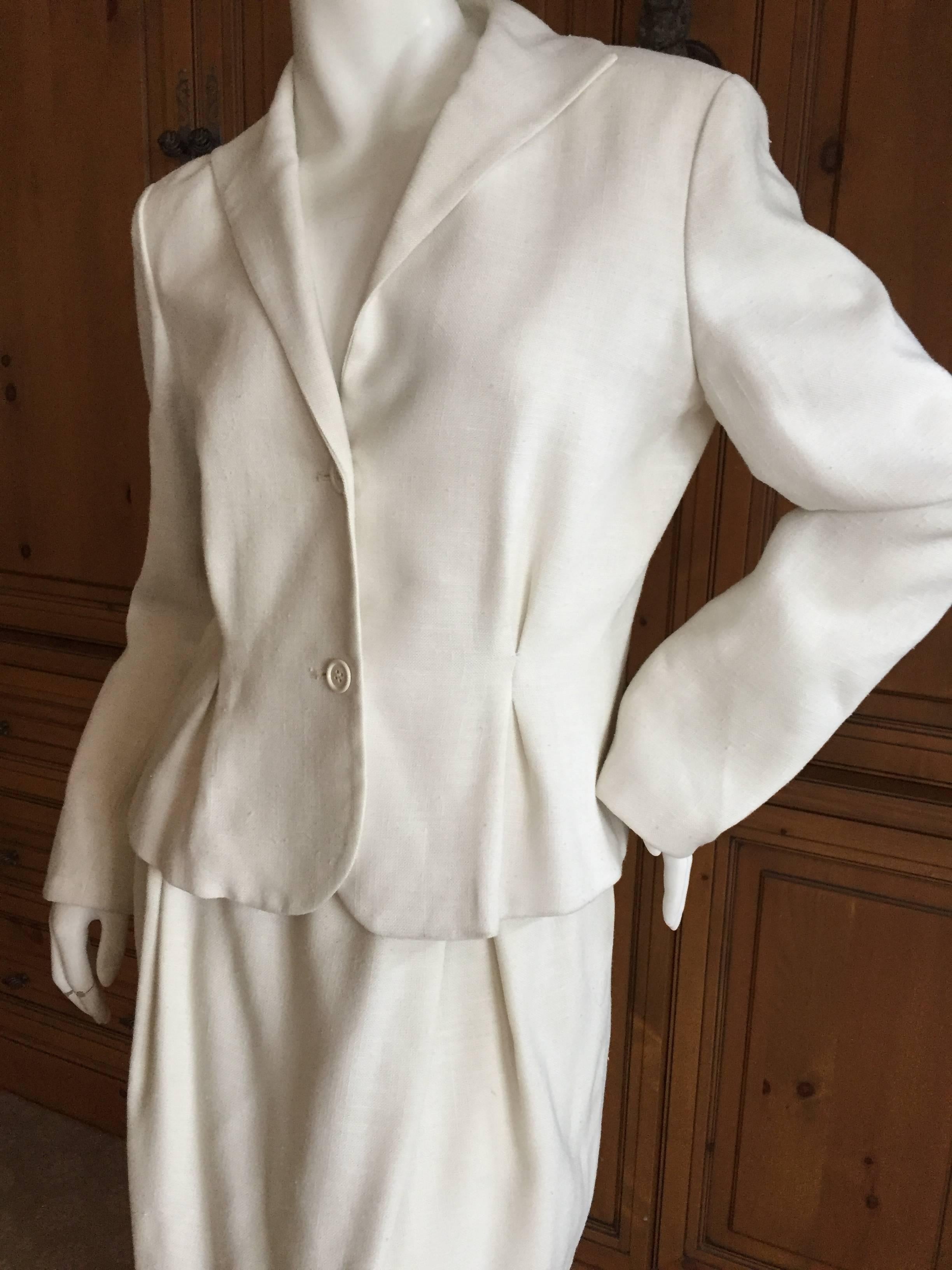 Crisply tailored ivory linen suit from Halston for I. Magnin circa 1972.
Skirt features inverted pleating at the waist, which is echoed in a pleat on the jacket. Very simple and elegant, pure Halston.
Jacket
Bust 38