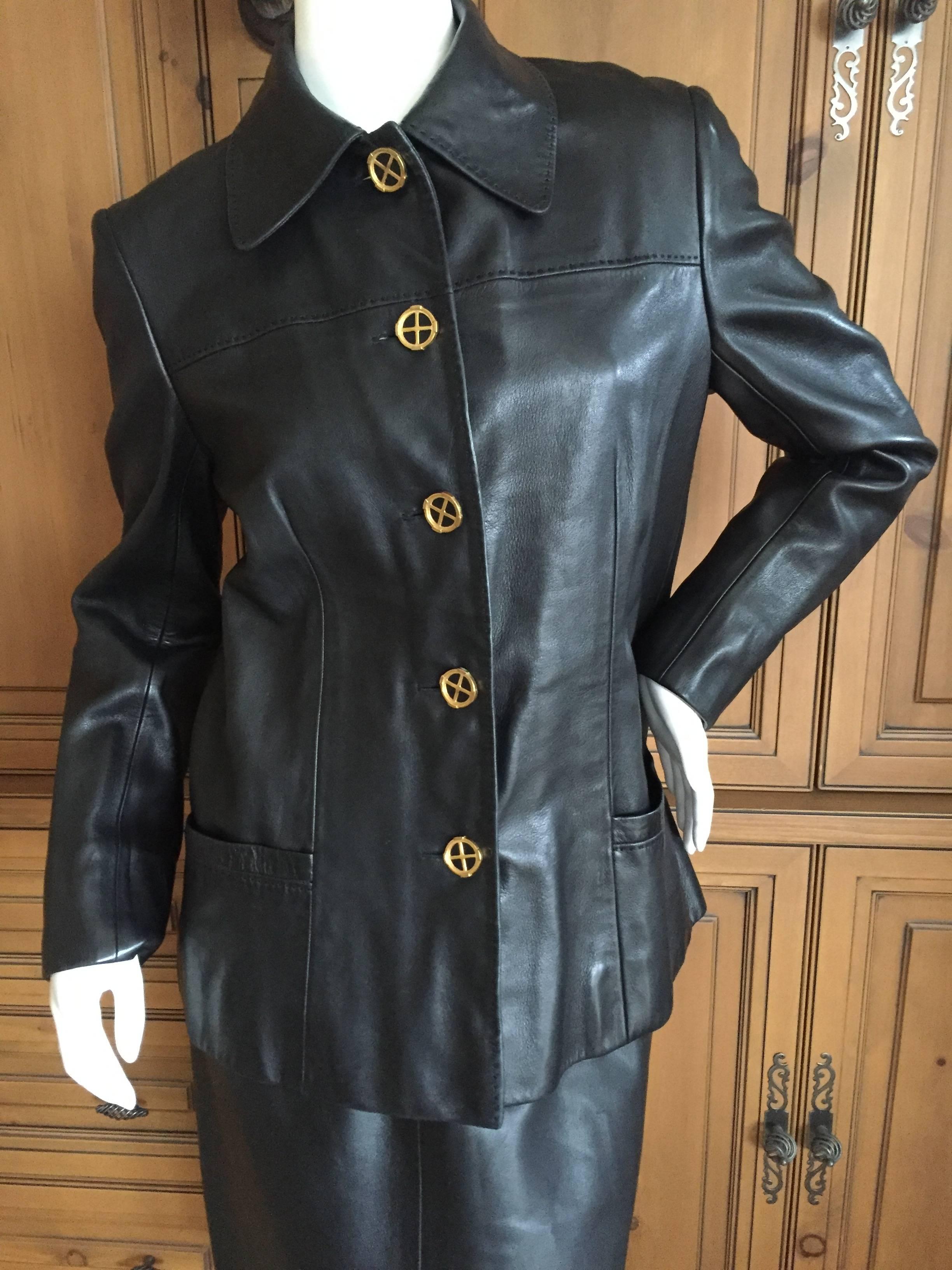 Luxurious black lambskin leather skirt suit from Hermes circa 1970.

This is a really special vintage suit. Leather insert buttons, this is fully lined in Hermes silk scarf fabric. Finished with top stitching , it is such a pretty jacket.
Even