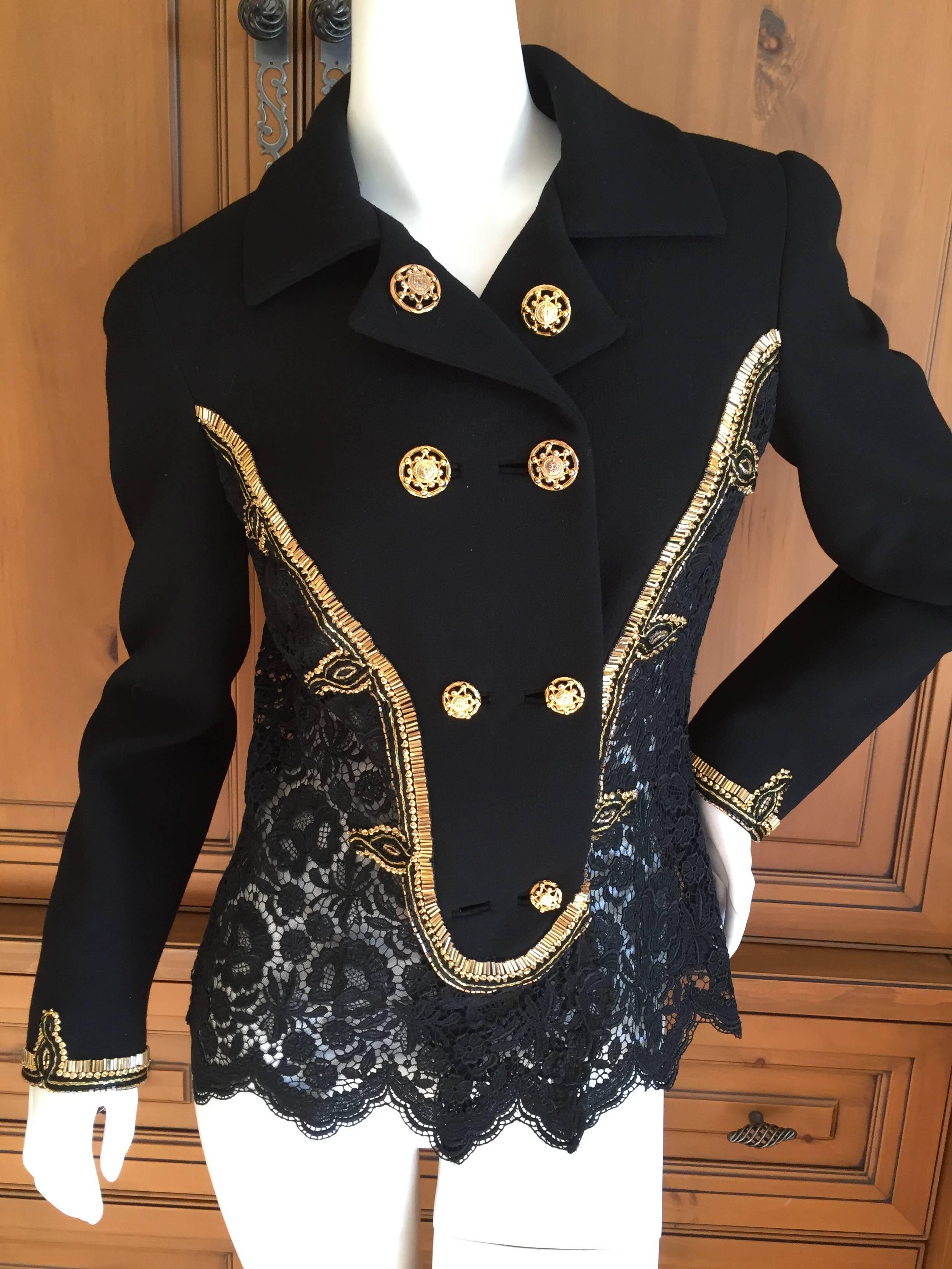 Black lace jacket with beaded embellishments from Gianni Versace Couture .
The details are so beautiful and include scalloped edging and gold bugle beads.
Missing one small button at bottom.
Size 40
Bust 39