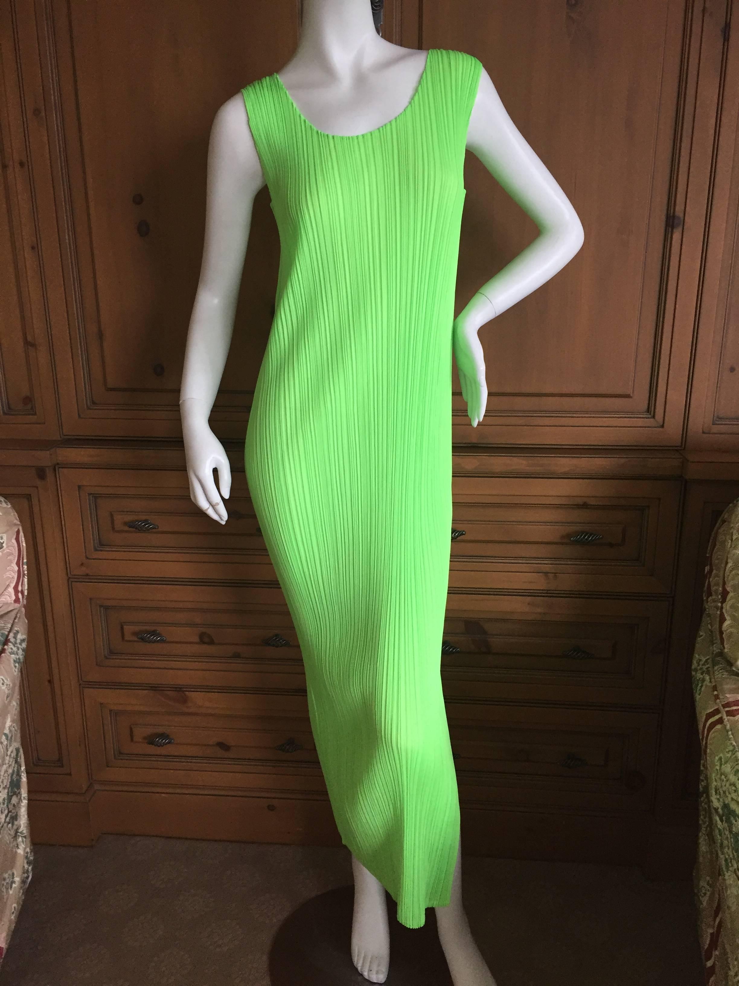 Iconic neon green pleated sheath dress with side slit from Pleats Please Issey Miyake.
Japanese size 3
There is a lot of stretch to this pleated fabric.
Bust stretches from 34