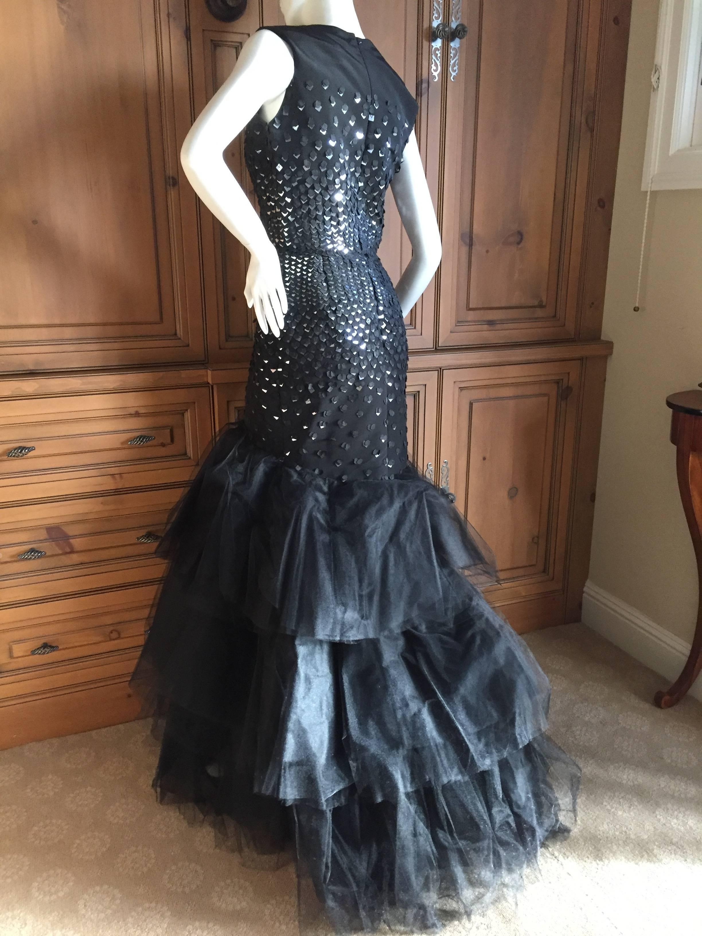 Black sequin mermaid gown from Oscar de la Renta.
Featuring a sleeveless sheath with fish scale style sequins in silver and black, and a wonderful layered tulle mermaid skirt. 
Beautiful entrance and exit maker.
Size 4
Bust 36