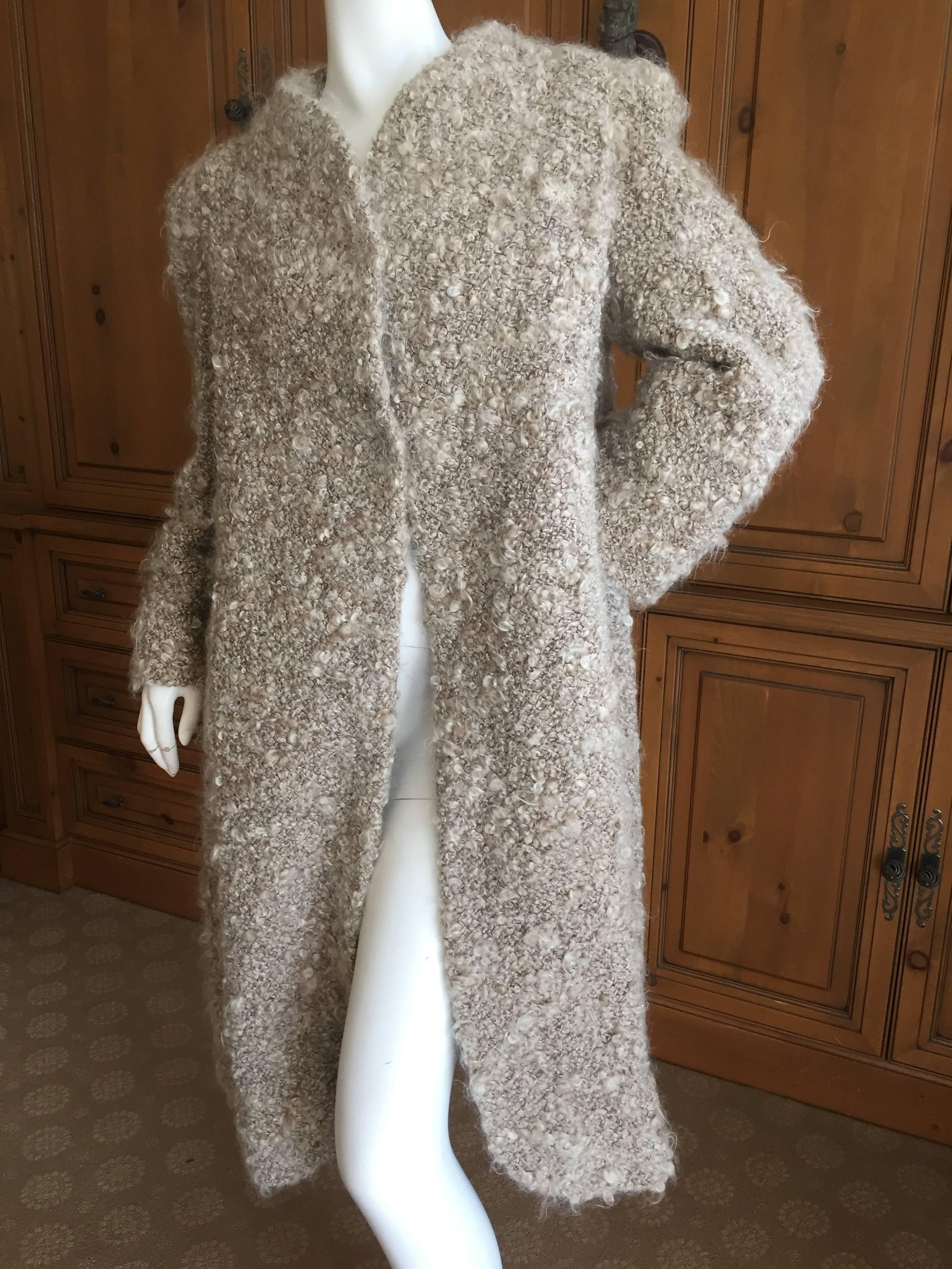 Unusual gray swing coat from Arnold Scaasi.
 Extremely textural nubby wool, this is really beautiful in person. 
Lined in silk taffeta, this is an early 1960's Scaasi. 
I show it belted for styling purposes, the belt is not included.
Bust