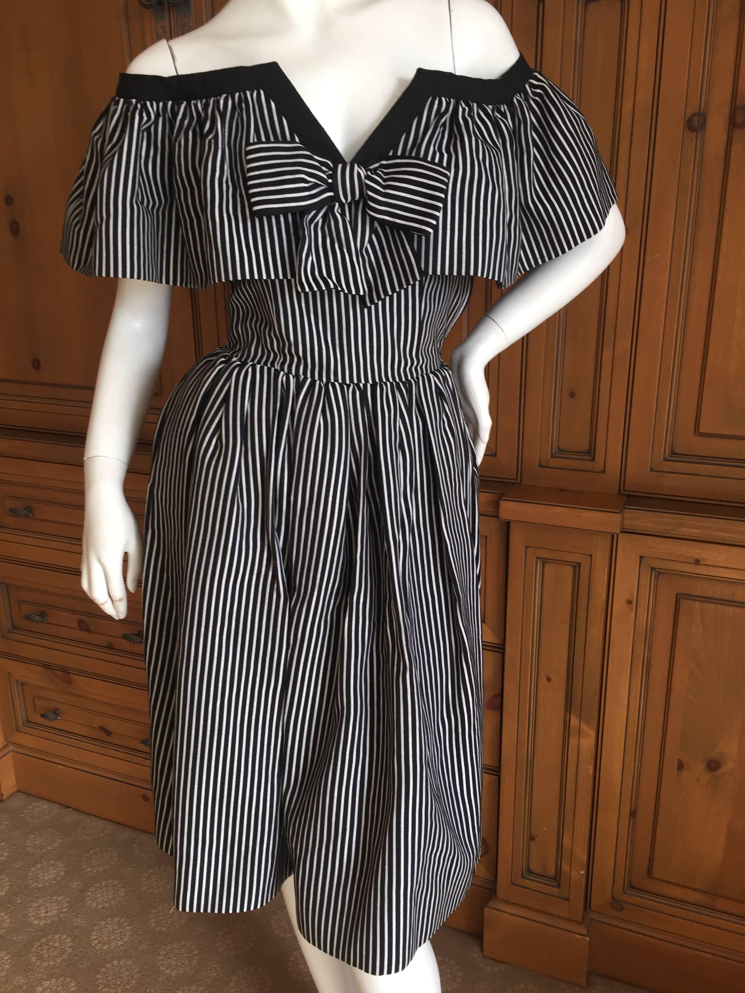 Wonderful black and white striped cotton day dress from Yves Saint Laurent  Rive Guache circa 1979.
Off the shoulder with black trim and an attached bow, this is such a sweet dress.
Size 36
