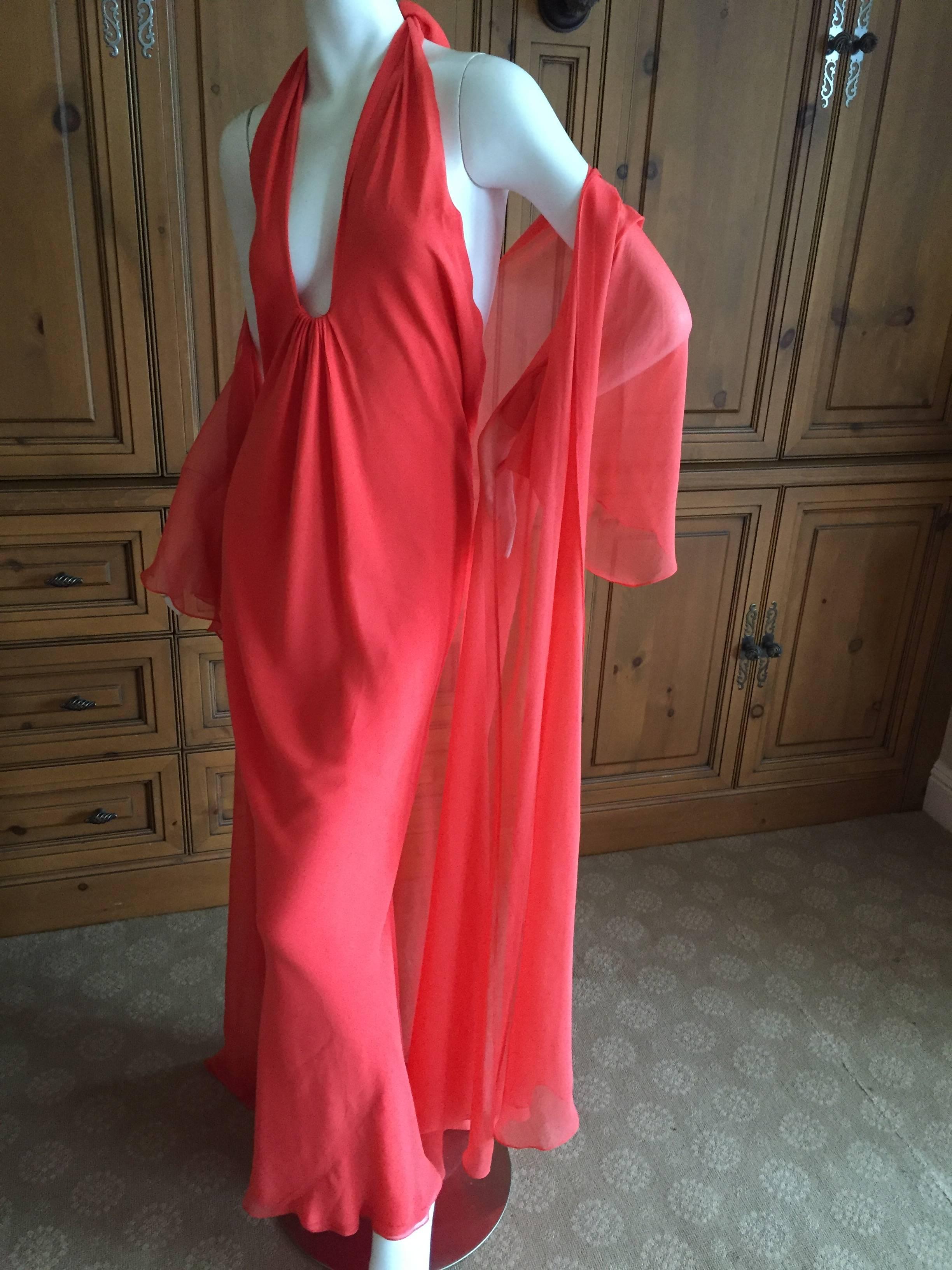 Halston 1970's Backless Low Cut Silk Chiffon Evening Dress & Coat.
In Tangerine silk chiffon, this is an amazing piece.
The dress ties in theh back and can be adjusted to wear very low, or less revealing, up higher around the neck.
Bust