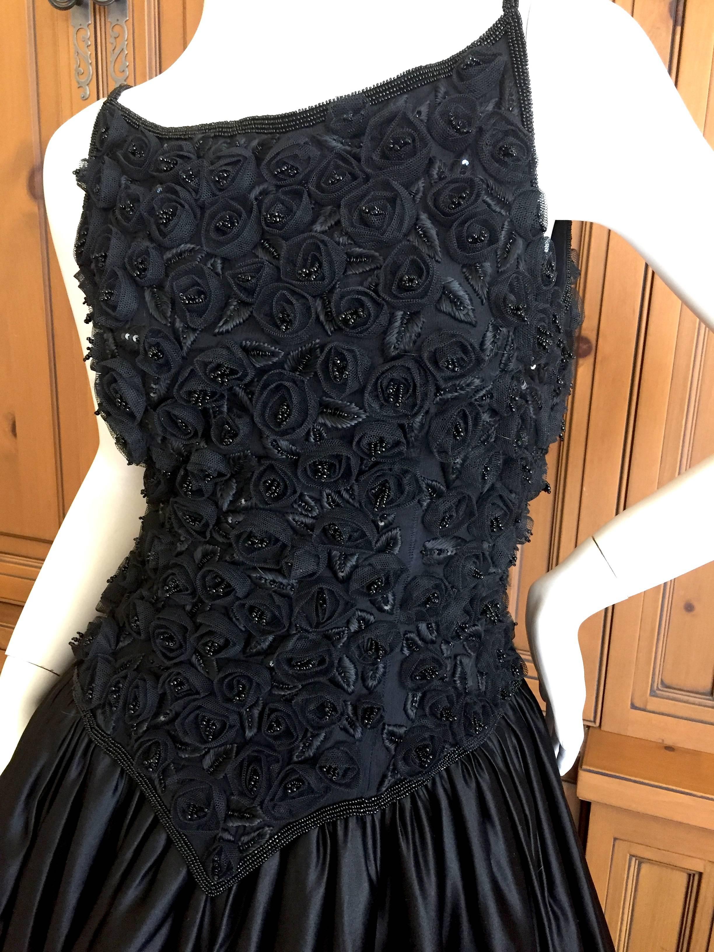 Magnificent evening dress from Yves Saint Laurent, from the 1970's.
Featuring a full skirt with four layers of tulle skirts for body, the bodice is finely embellished with hand made floral rosettes of horsehair & beads with embroidered leaves from