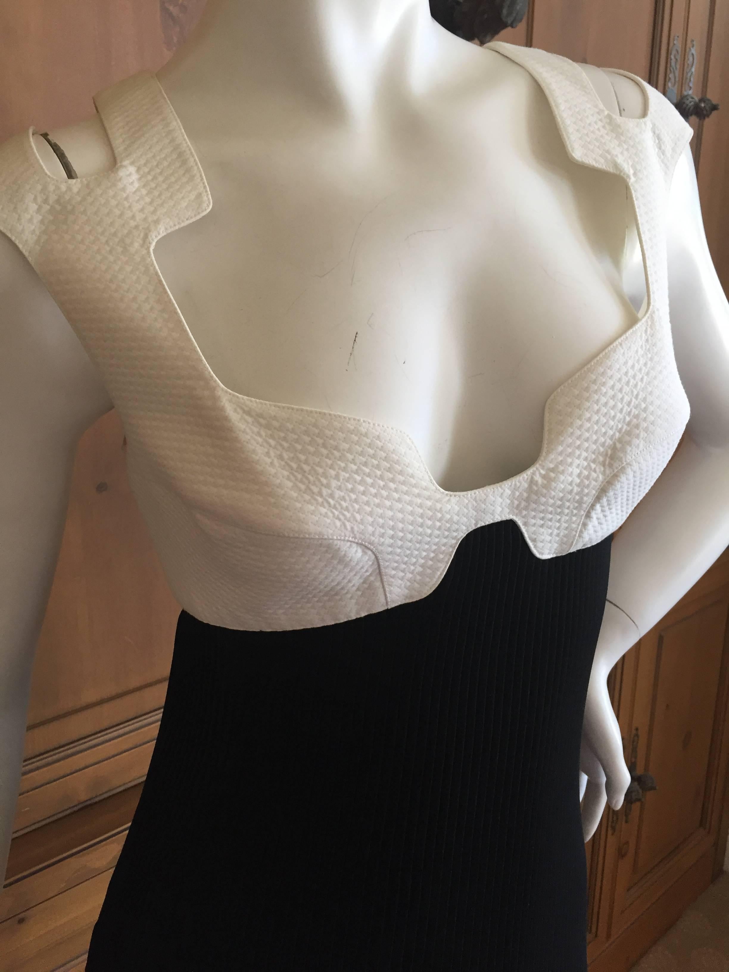 Wonderful low cut black and white dress from Thierry Mugler circa 1988.
The top is white cotton pique, cut with a revealing decolettage and shoulders.
The bottom is a ribbed fabric , which has a lot of stretch for size.
Size 38
Bust 38 
Waist