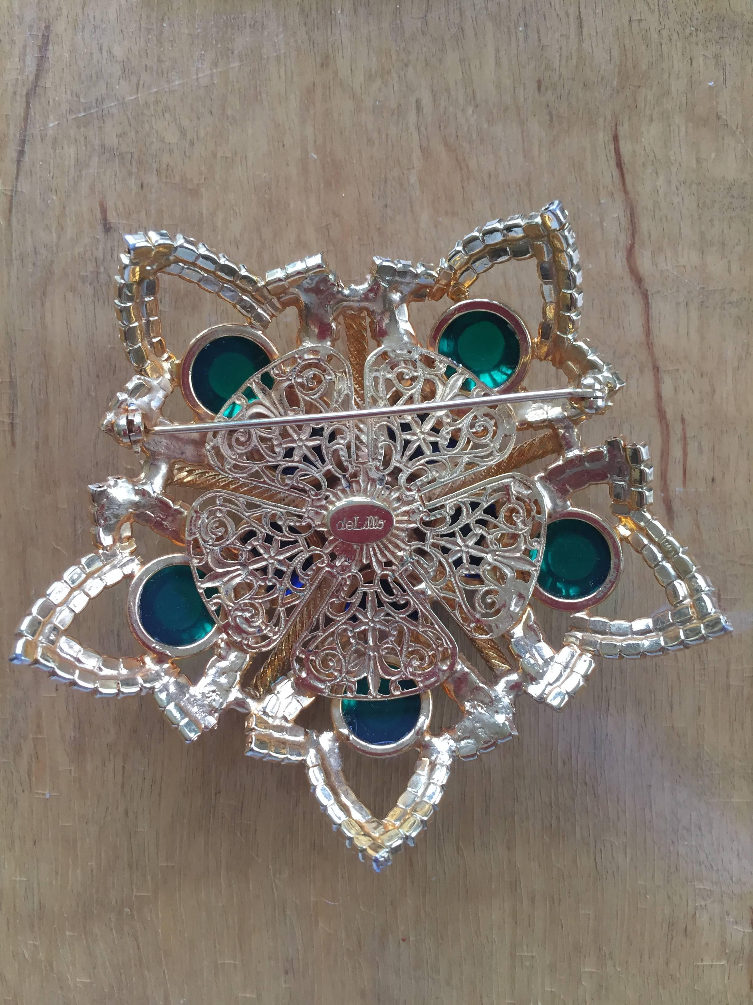 Wonderful jewel tone brooch by William De Llillo measuring just under 4" across.

William De Lillo was a jeweler with a background in fine jewelry who designed for Miriam Haskell for many years before designing under his own name. He designed