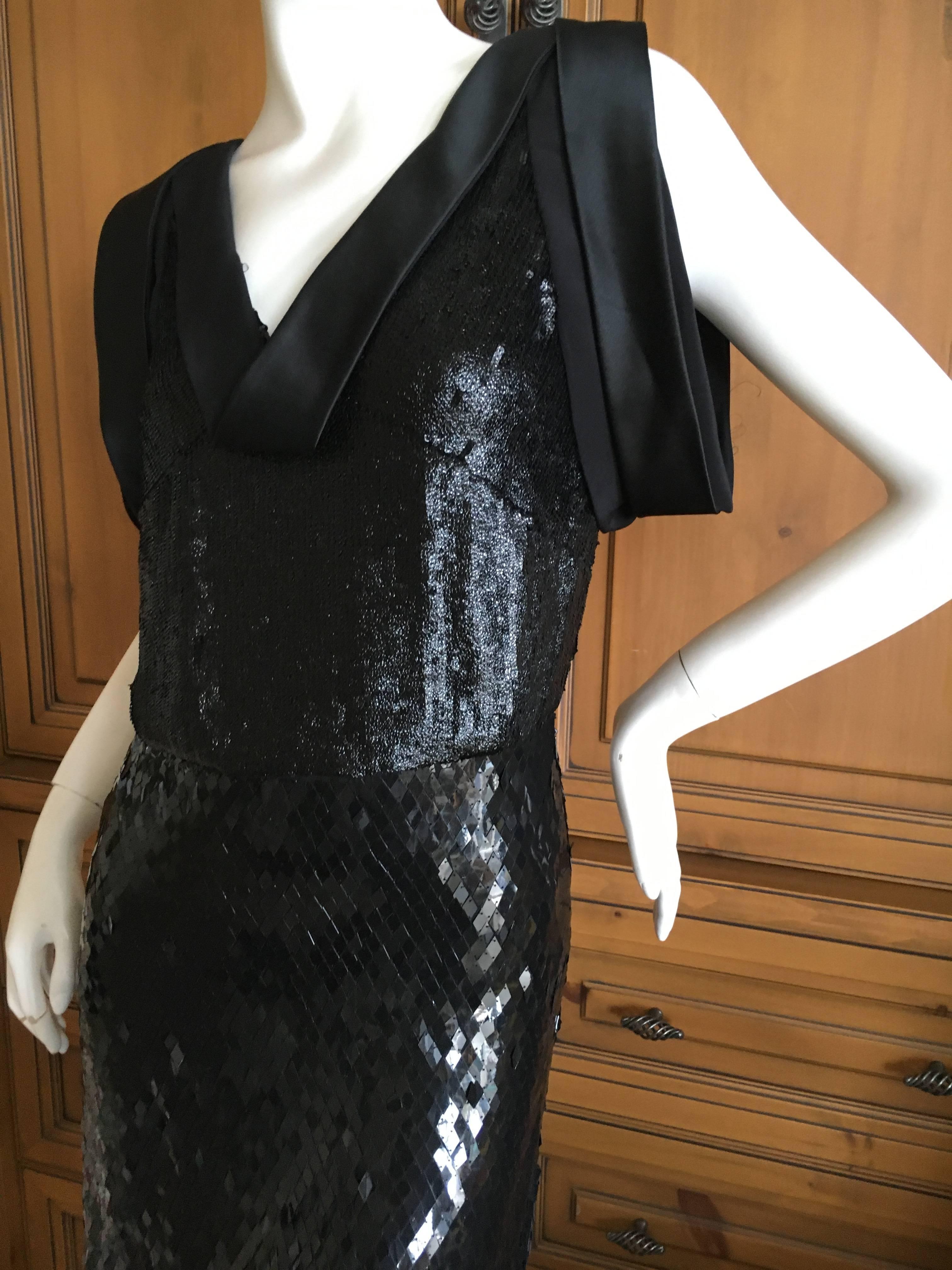 Shimmery little black cocktail dress from Gucci. 
This has a delightful shine to it that is difficult to capture in photos.
Side zipper.
Size 38
Bust 38