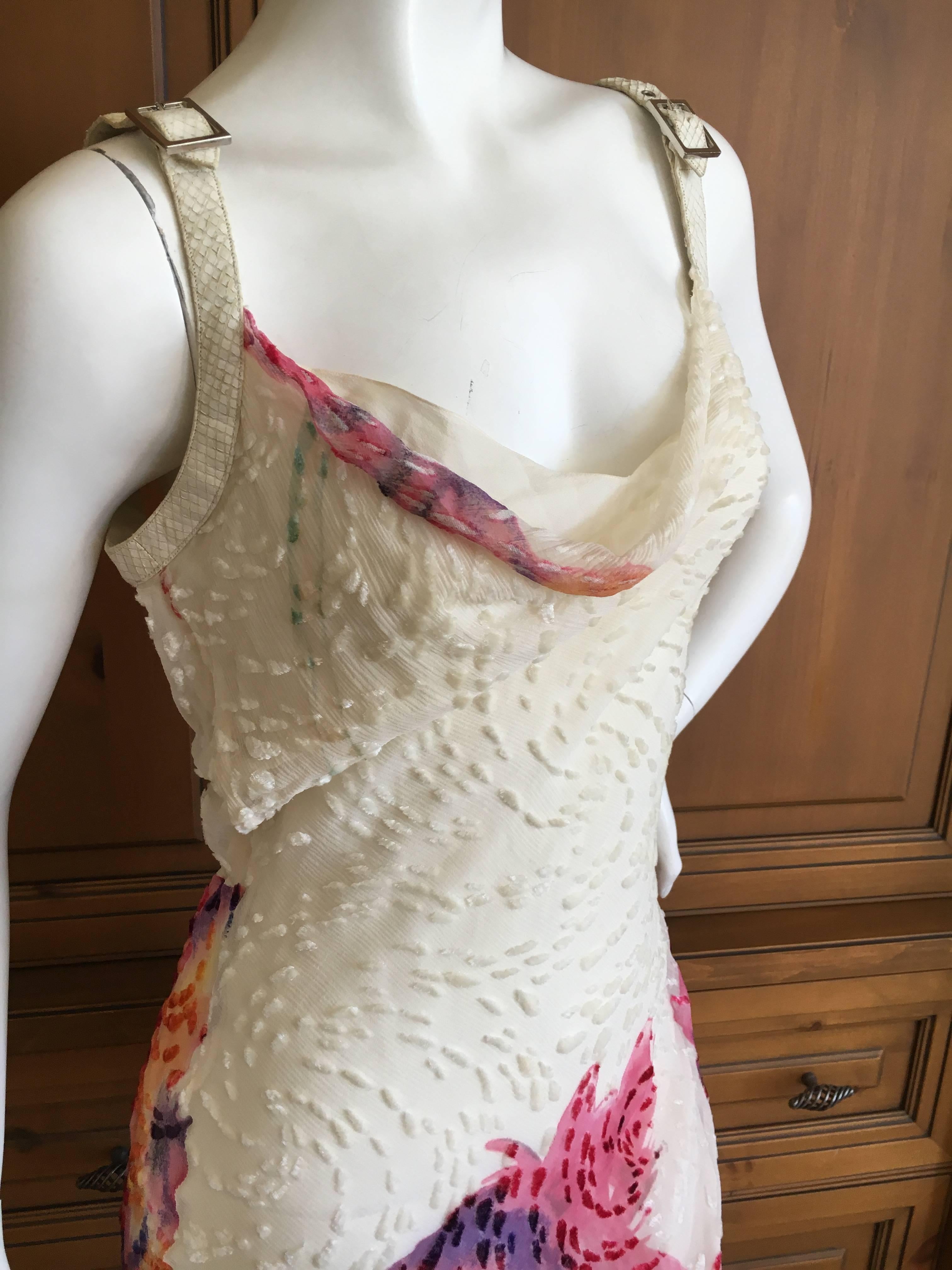 Christian Dior Bias Cut Ivory Devore Velvet Dress with Snakeskin Straps.
The fabric is a beautiful devore vevet with a colorful abstract floral pattern splashed across the bottom.
The straps are natural snakeskin lined with leather, which are