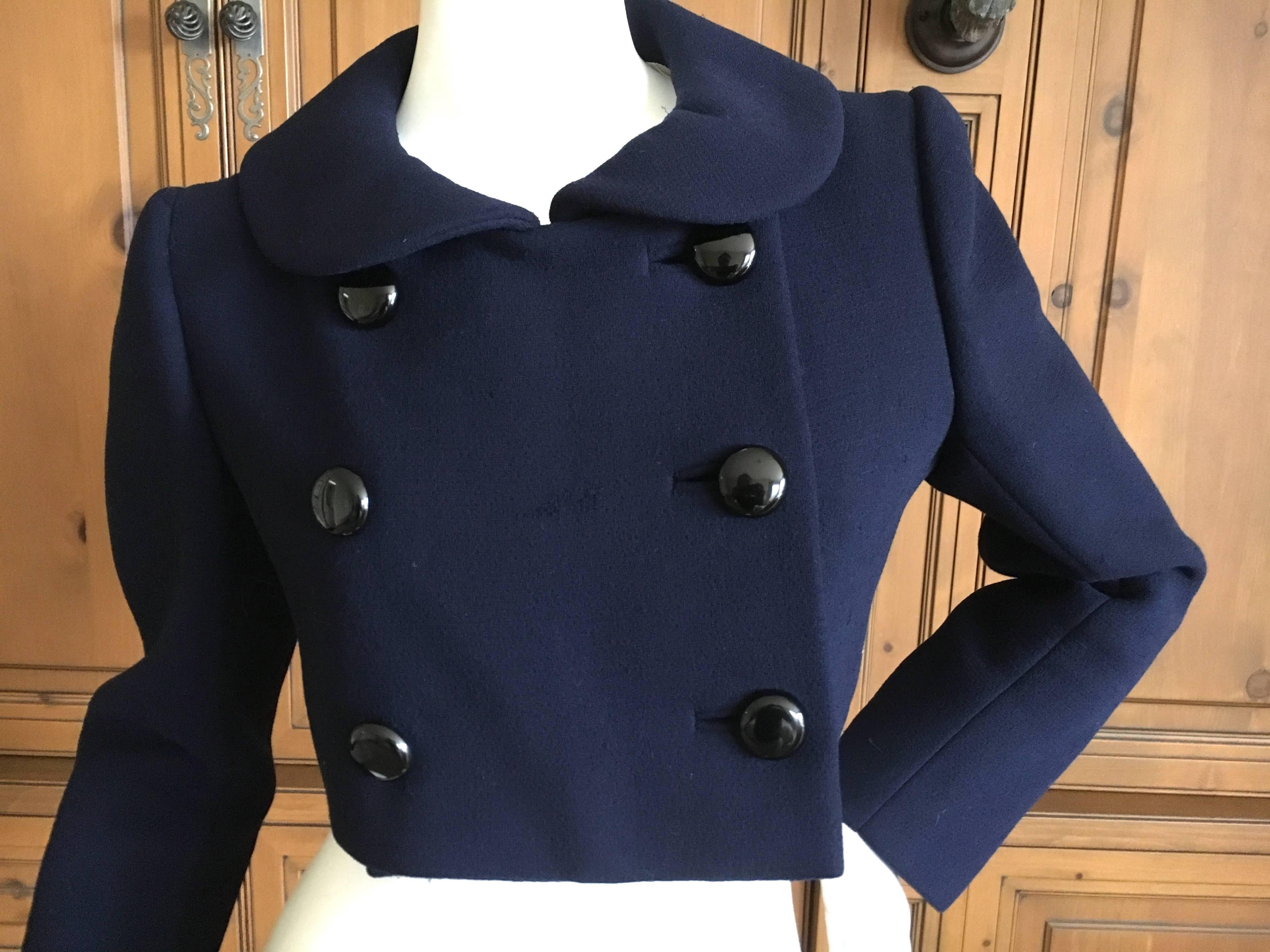 Norman Norell Navy Blue Cropped Jacket.
Lined in silk, navy blue wool with bold black buttons.
Bust 38