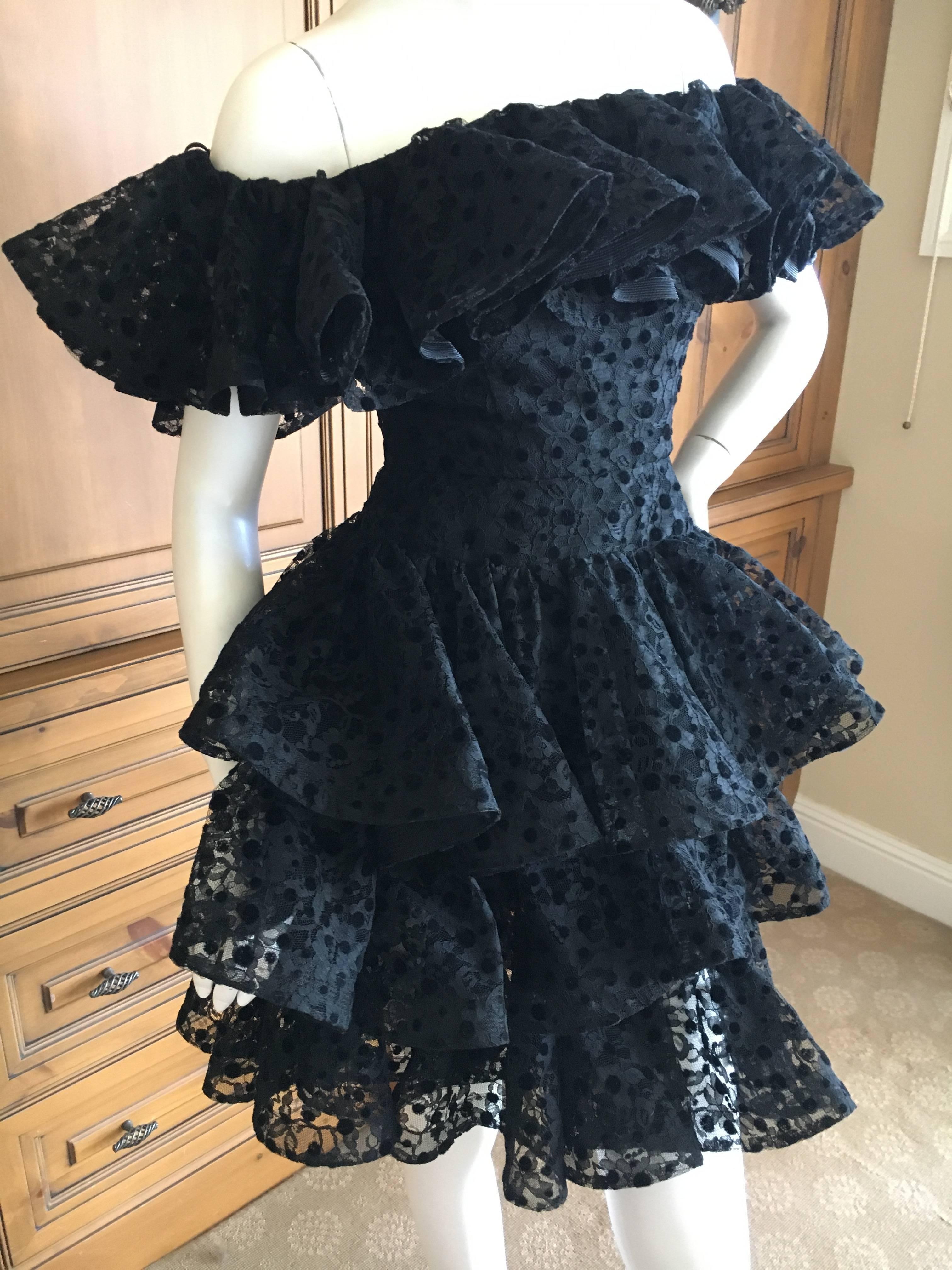 Delightful off the shoulder dress from Arnold Scaasi, circa 1984.
The floral lace has polka dot's, and ruffled tiers .'
Bust 36