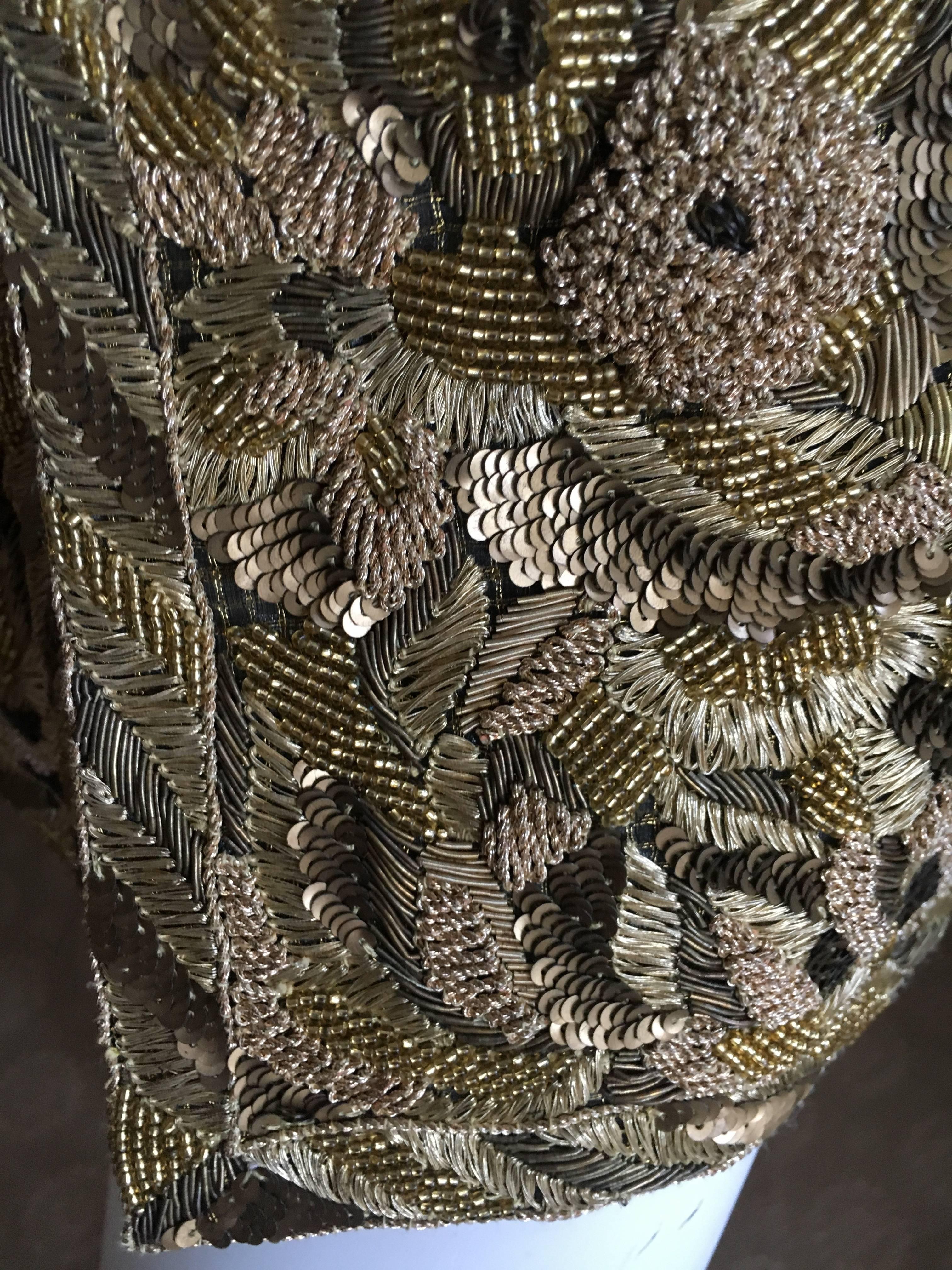 Astonishing Haute Couture gold embellished long jacket or mini dress from Pierre Balmain.
Numbered , from Fall 1998, this was designed by Oscar de la Renta, the beadwork executed by the house of Lesage.
The hand embellished beadwork must have