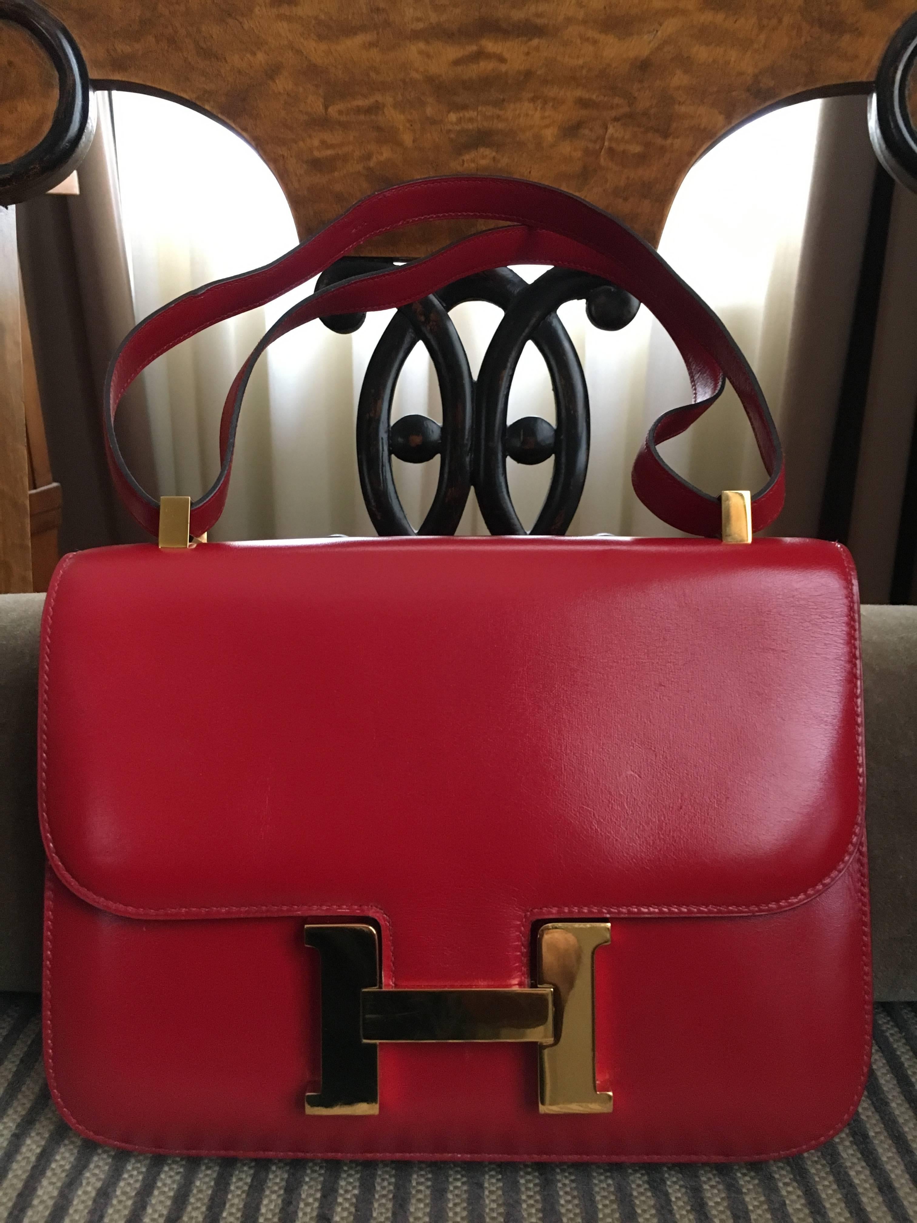 Hermes Authentic Red Calf Leather Constance Bag
 24 cm
Gold Hardware
I can't make out the letter inside the circle time stamp. 
The circle was used from 1971 -1996.
So it's before '96, but I'm not certain the exact age.

9