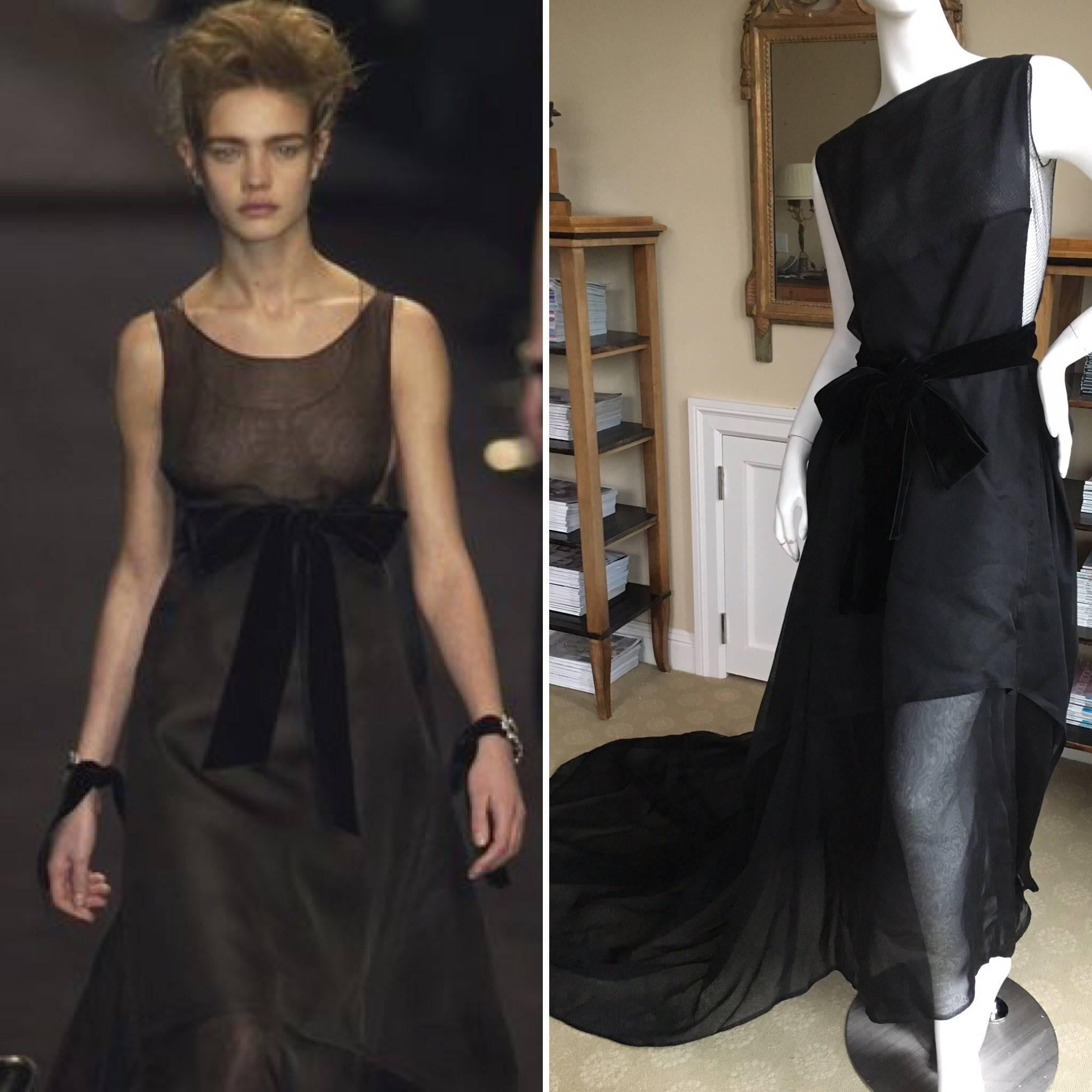 Saint Laurent by Tom Ford Fall 2002 Final Look Black Wedding Dress modeled by Natalia Vodianova
This is an astonishing piece, it has three parts.
 A very fine net tank, the dress with a mile long train, and the velvet sash.
There is no size tag,