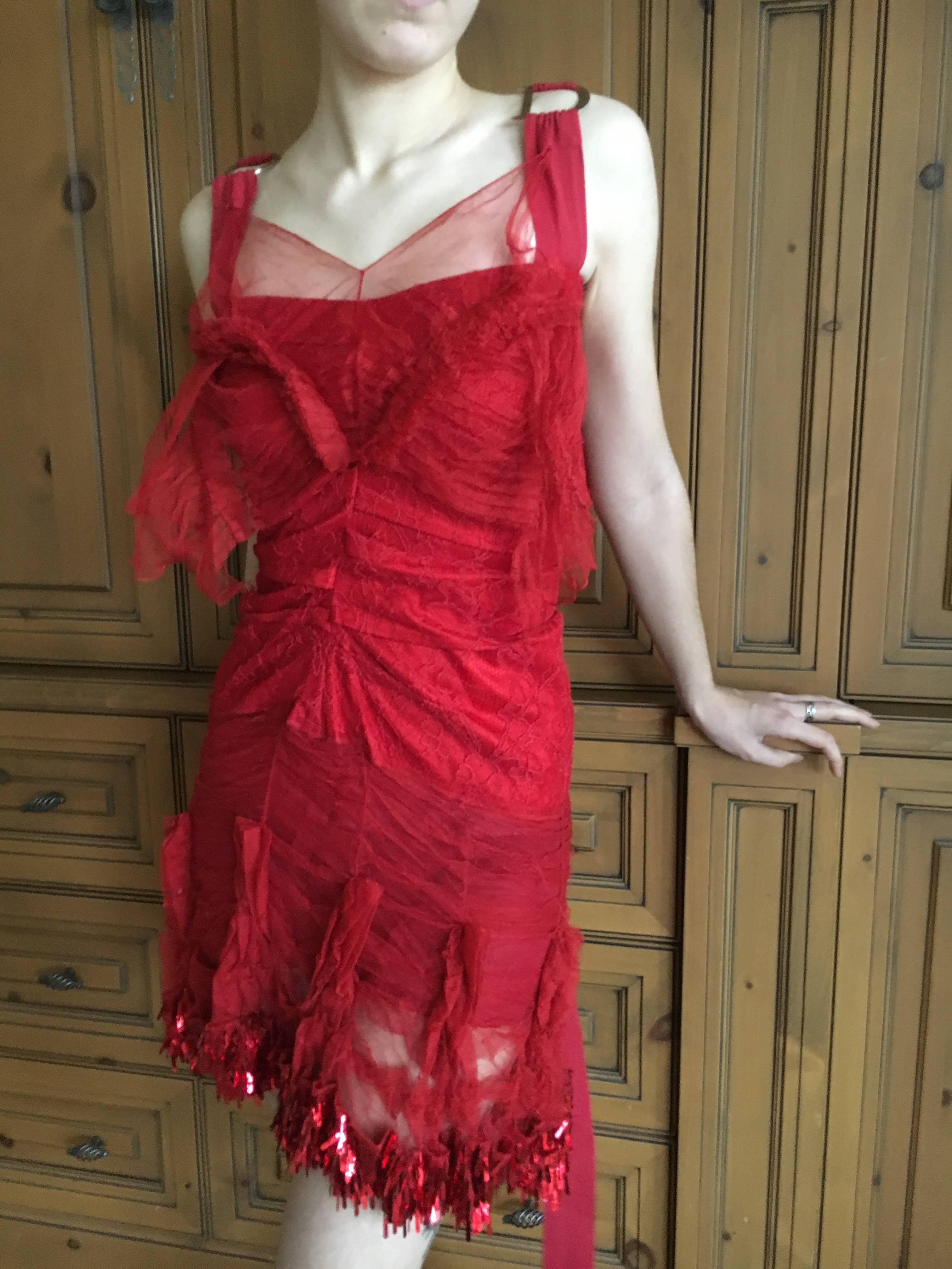 Beautiful red lace cocktail dress by John Galliano for Christian Dior.
Trimmed with red paillete sequins at the hem, with large 