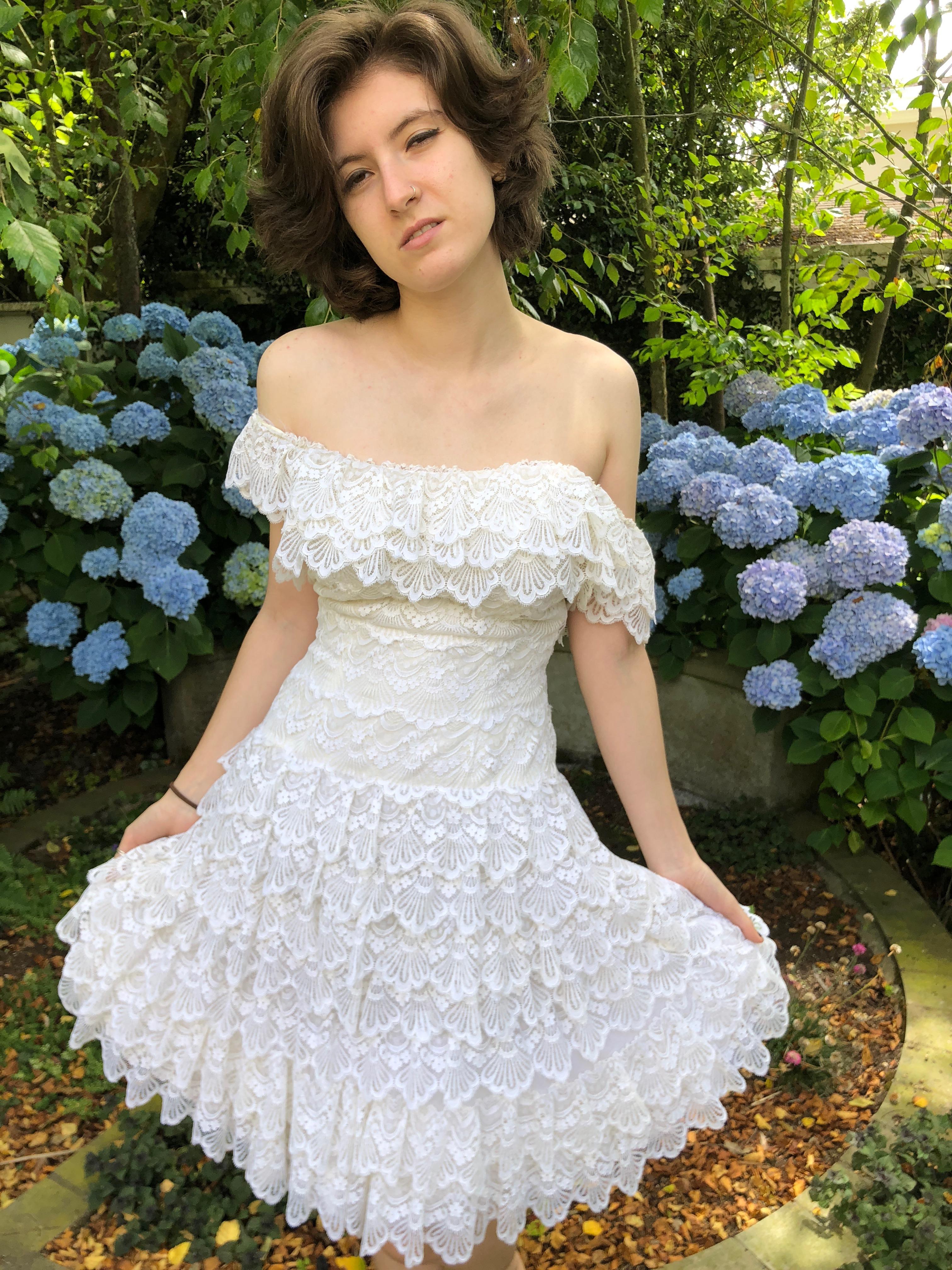 Exquisite tiered lace off the shoulder dress from Loris Azzaro.
This is from the early 1970's and would make a wonderful alternative wedding dress.
This is quite small, I would estimate it to be a French size 36, US 4.
Bust 36