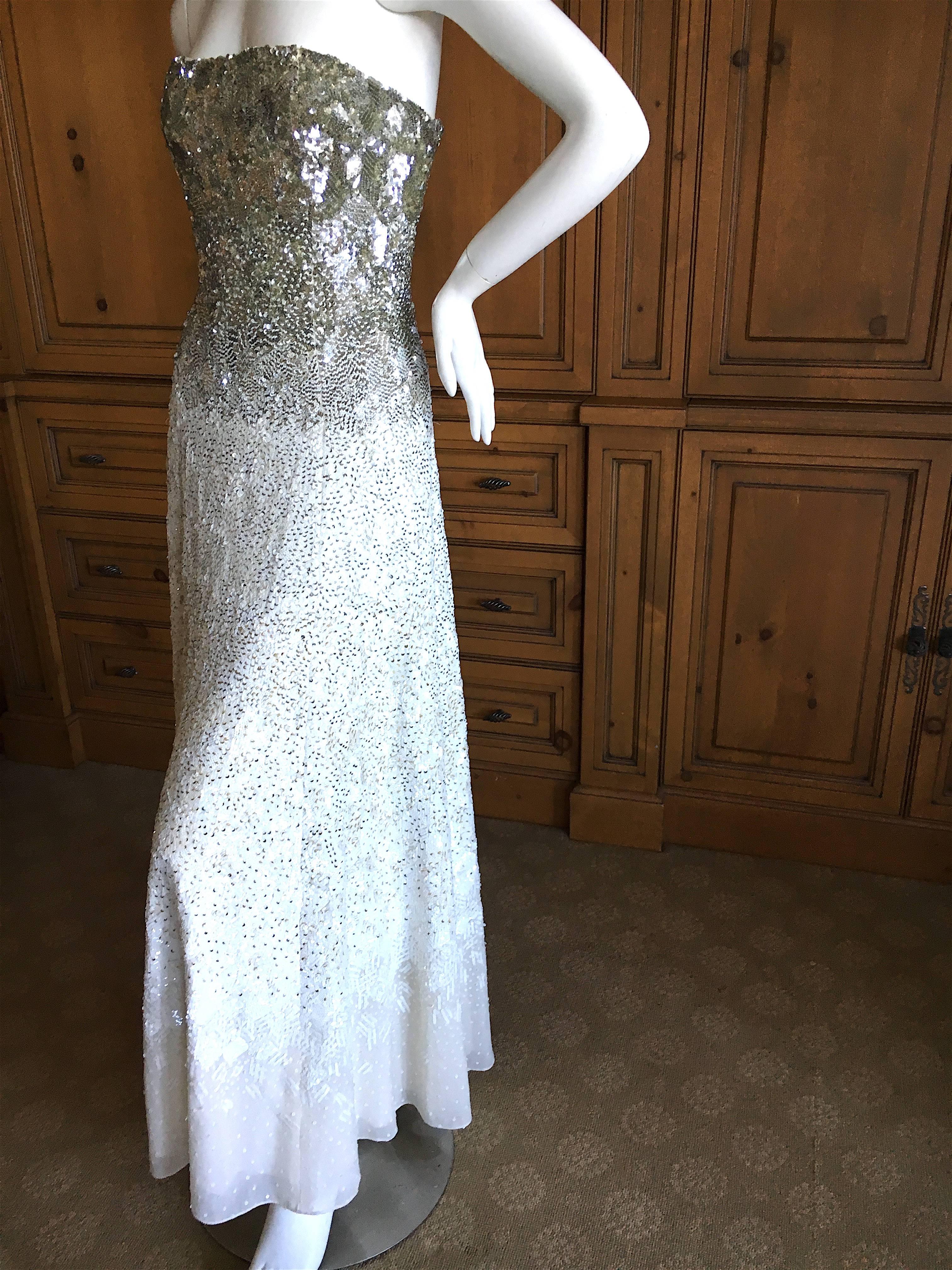 Oscar de la Renta Strapless Silver & White Sequin Evening Dress with Built in Corset.
This is extraordinary, the photos don't capture this completely embellished evening dress.
Size 0
Bust 33"
Waist 24"
HIps 44"
Length