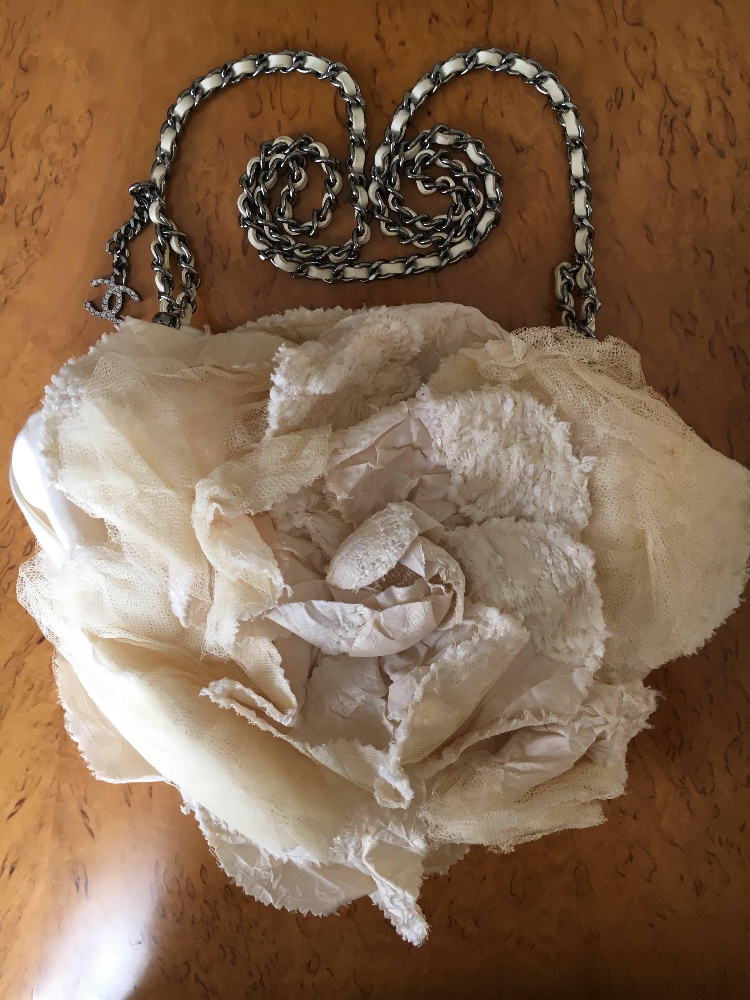 Rare soft Camellia flower clutch hand bag from Chanel.
There is a silver tone chain strap laced with white leather.
Appx 8