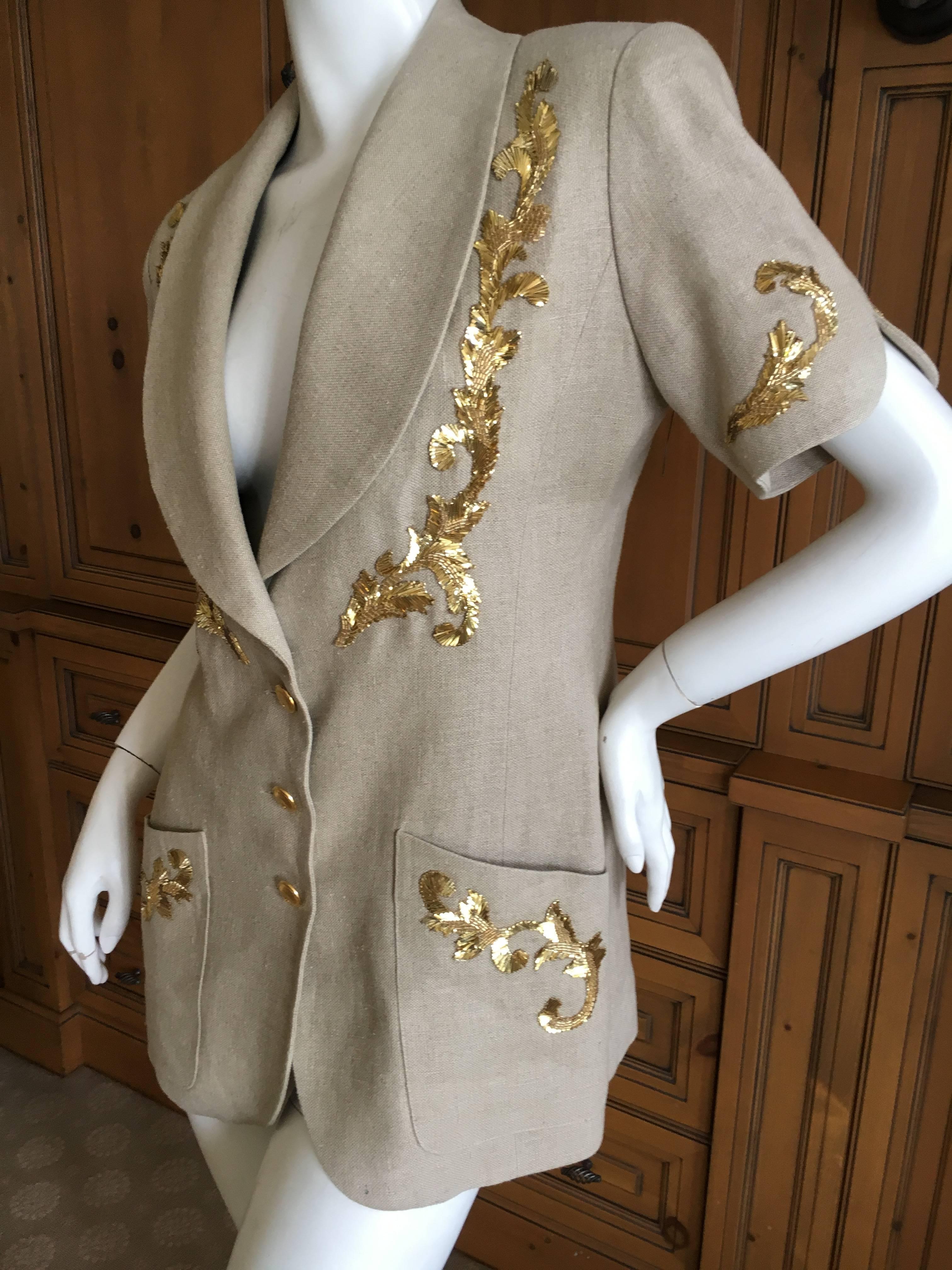Wonderful vintage short sleeve jacket with goldwork and beading in baroque cartouche patterns by Lesage for Chanel.
There is no size label, it is appx size 40
Bust 40"
Waist 32"
Length 34"
Excellent condition