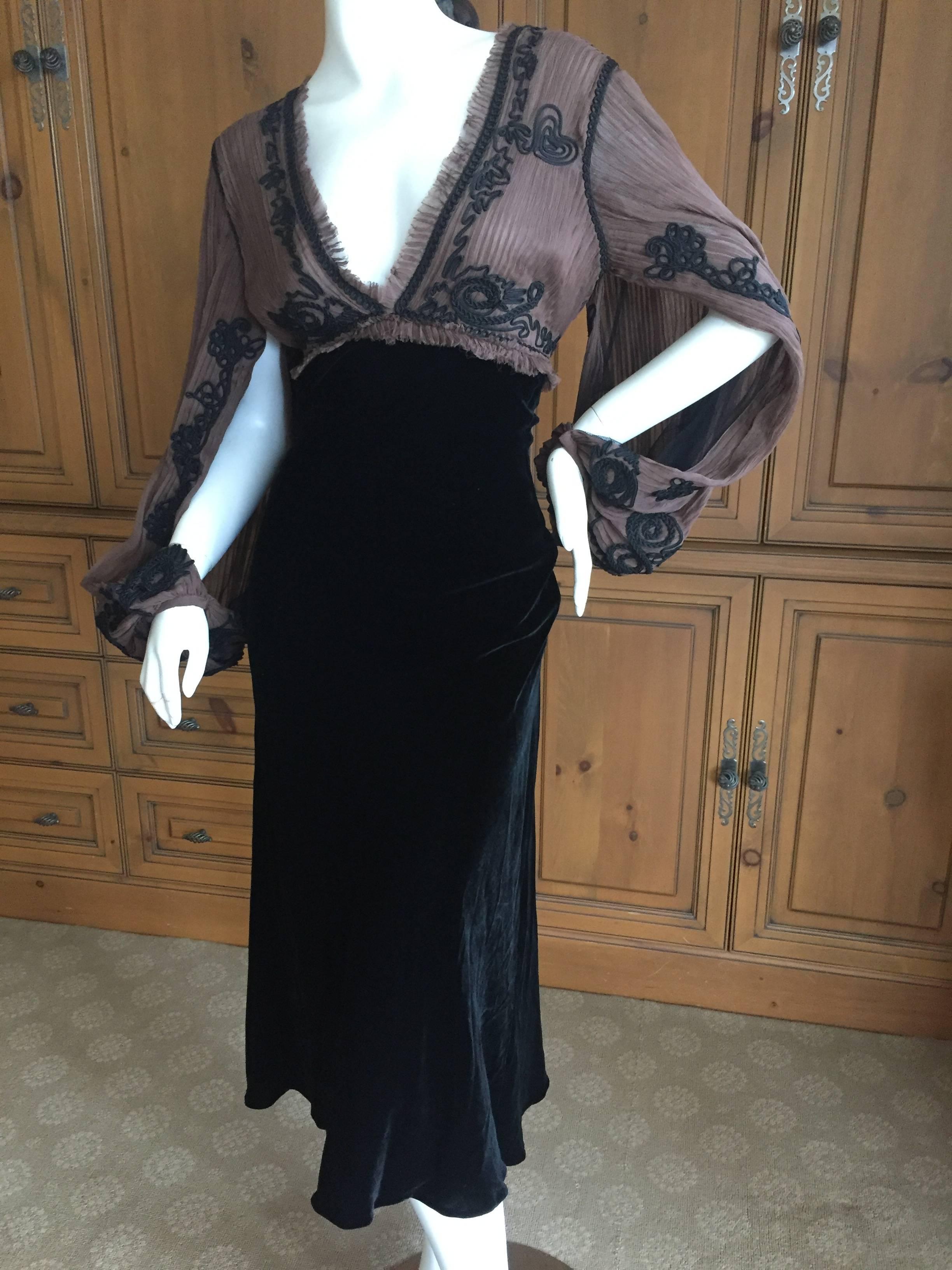 Wonderful vintage dress from Jean Paul Gaultier.
Featuring a velvet skirt with sheer top, trimmed in black soutache with convertible kimono sleeves which snap at the cuff and can be worn numerous ways.
Size 44
Bust 42