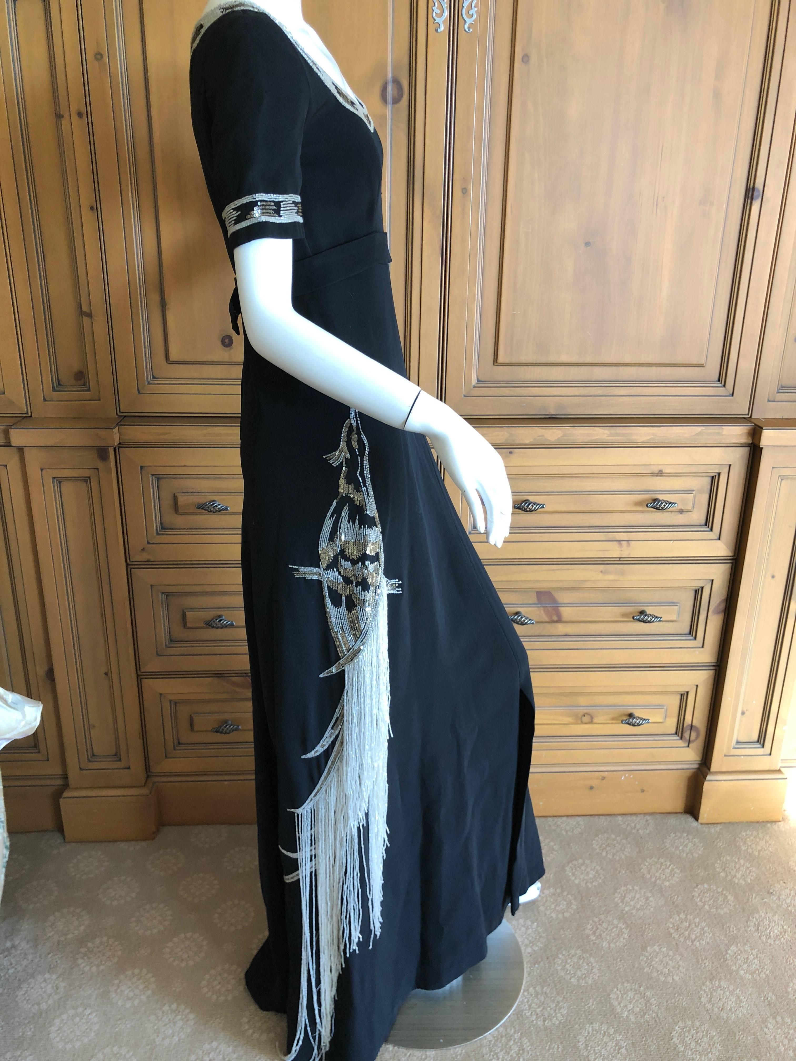 Cardinali Black Evening Dress with Bead Trim Fringed Bird Of Paradise

From the Archive of Marilyn Lewis, the creator of Cardinali
Cardinali was founded in Los Angeles in 1970, by Marilyn Lewis, who had already found success as the founder and owner