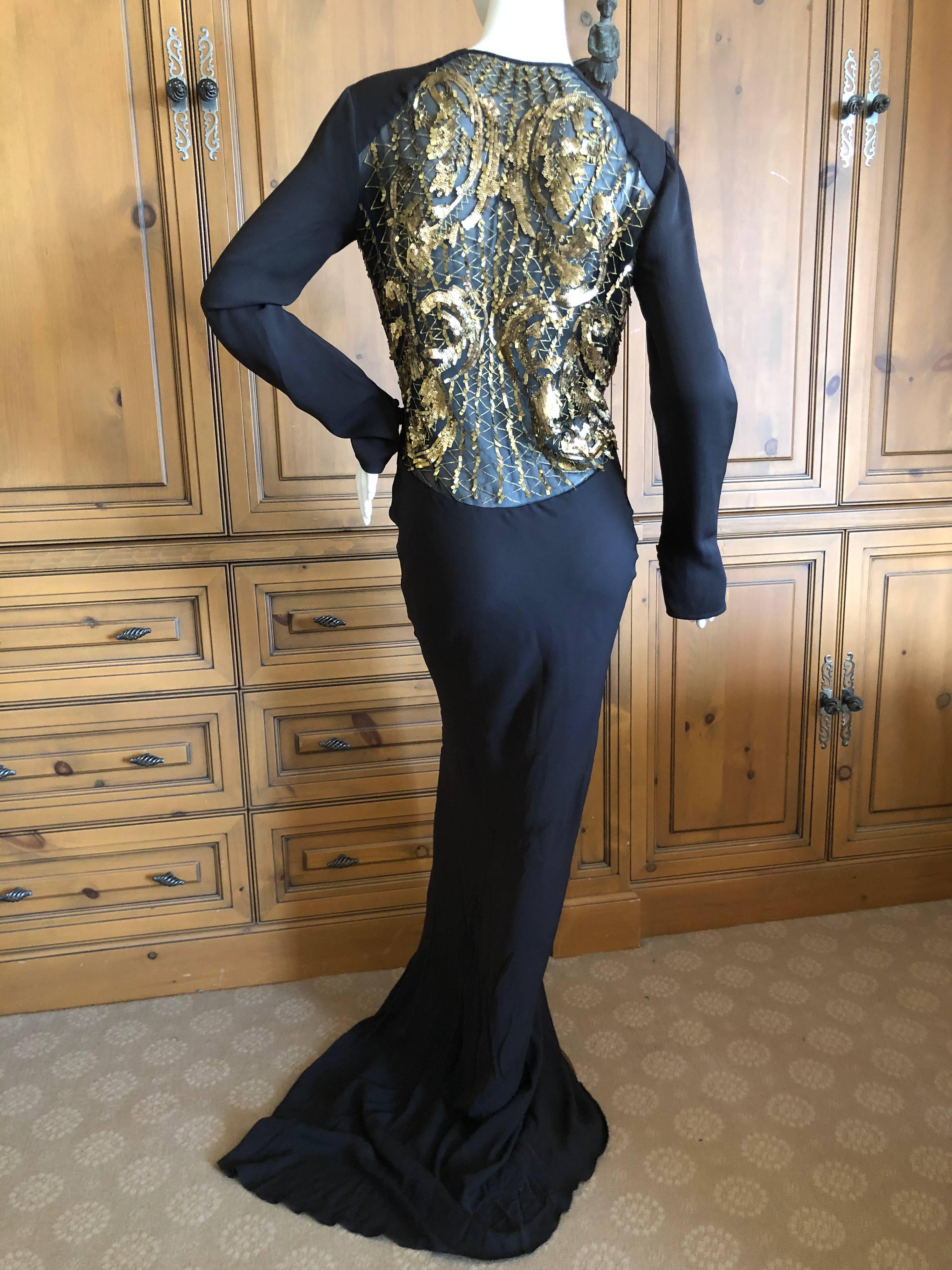 Roberto Cavalli Vintage Black Evening Dress with Gold Sequin Embellishment  .
The back and sides are sheer with exquisite gold sequin baroque pattern embellishments.
Much prettier than the photos.
Size 42
Bust  38