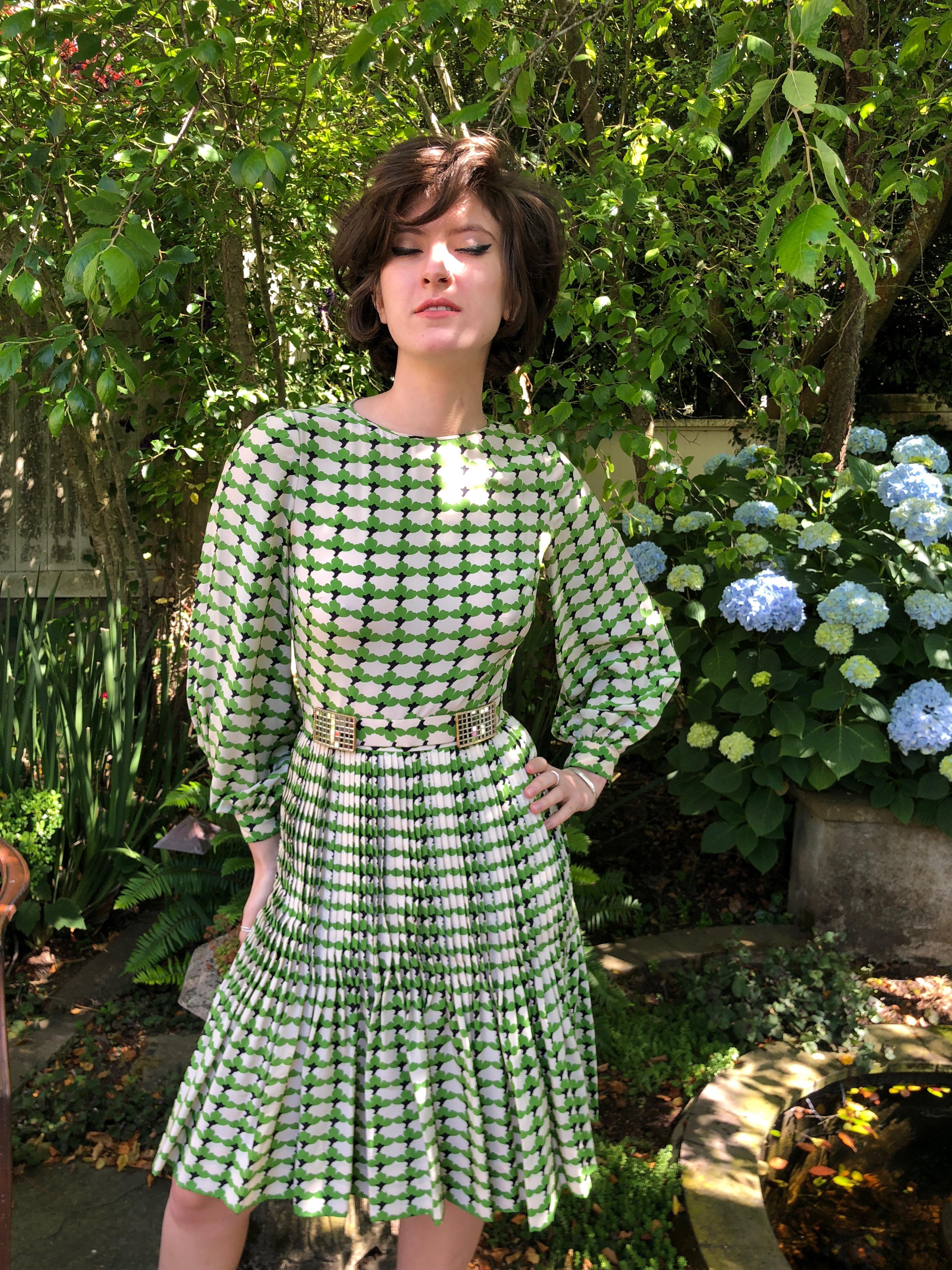 Cardinali Green Poet Sleeve Pleated Kick Skirt Day Dress with Disco Ball Belt
From the Archive of Marilyn Lewis, the creator of Cardinali
Cardinali was founded in Los Angeles in 1970, by Marilyn Lewis, who had already found success as the founder