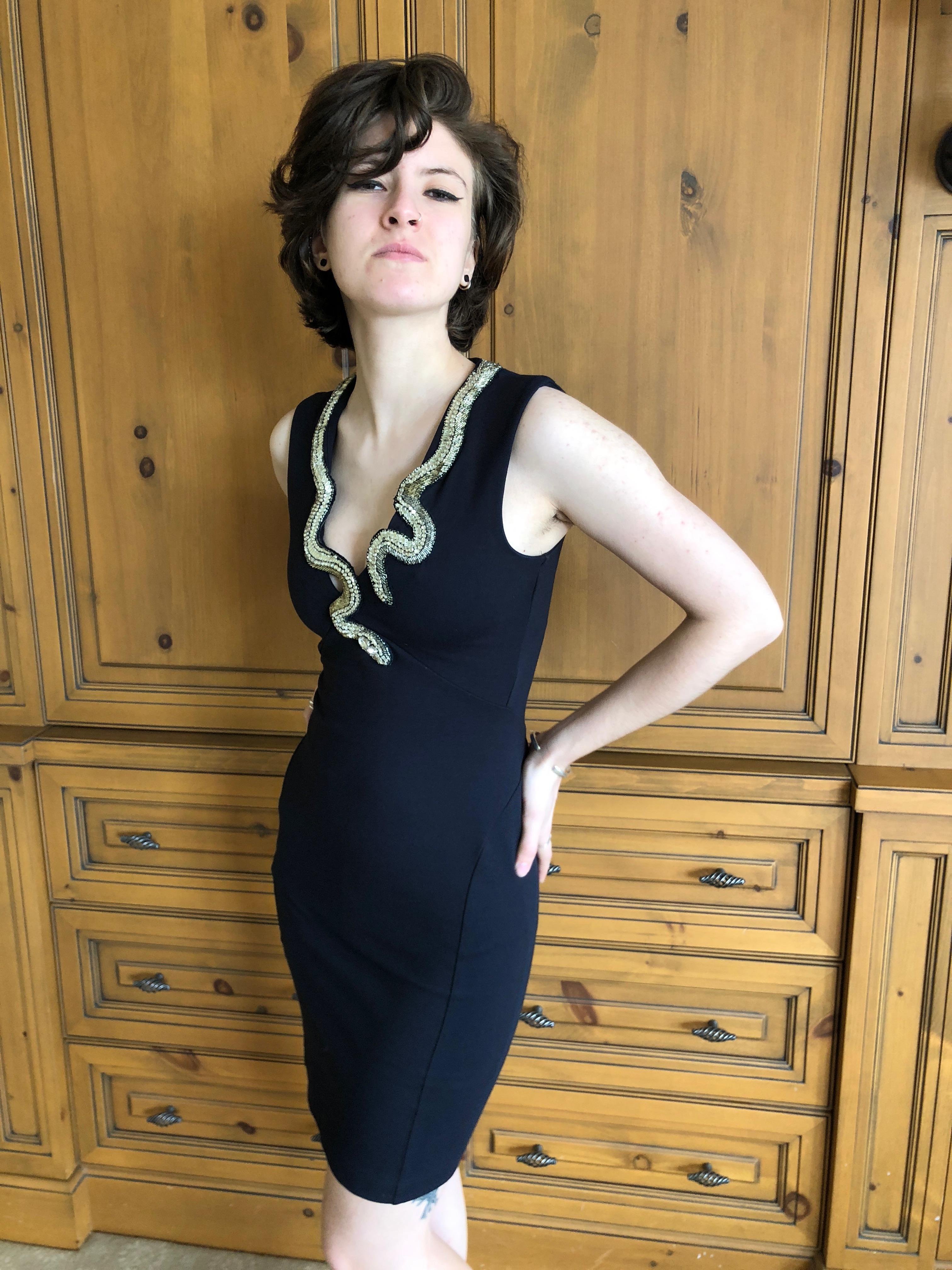 Roberto Cavalli Vintage Black Bodycon Dress with Embellished Snake Collar.
Who created the first snake embellished fashion? Ask Eve
This is amazing, very stretchy dress, hugs all the right places.
 Size 38 
Measurements given un stretched
 Bust 34