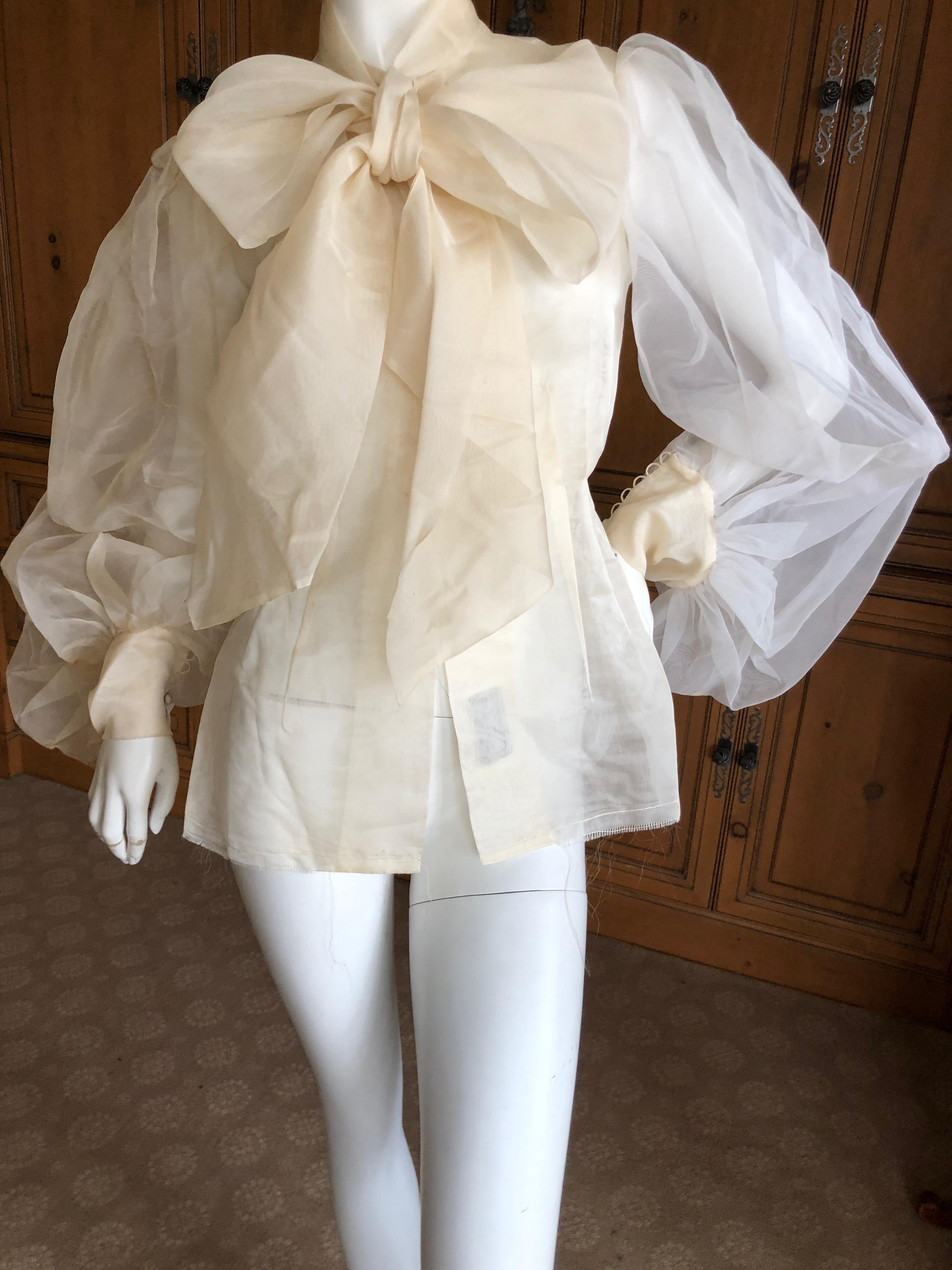 Cardinali Sheer Ivory Silk Bluse with Dramatic Sleeves and Bow  Fall 1971 

From the Archive of Marilyn Lewis, the creator of Cardinali
Cardinali was founded in Los Angeles in 1970, by Marilyn Lewis, who had already found success as the founder and