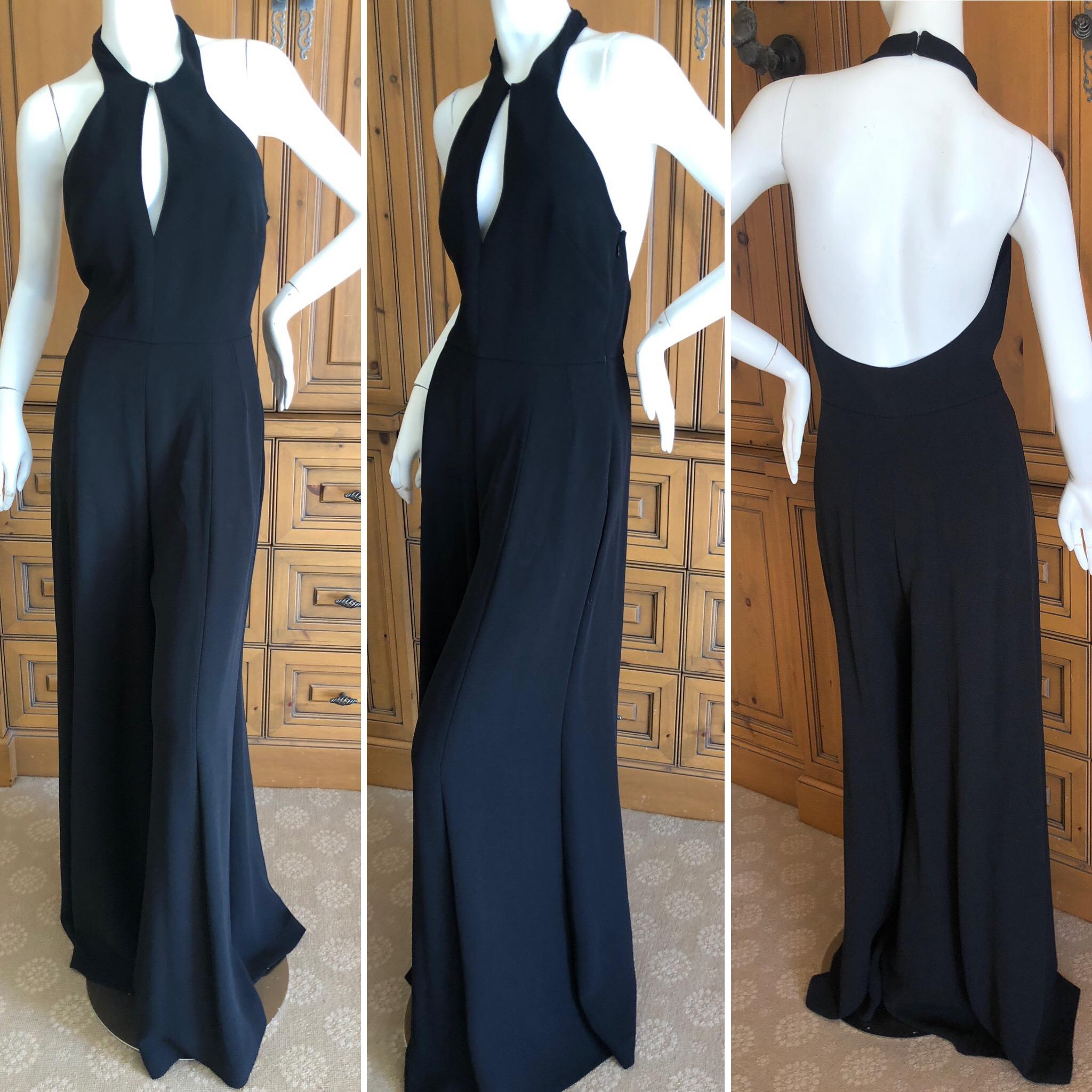 Yves Saint Laurent Vintage Black Silk Keyhole Halter Style Wide Leg Jumpsuit, Spring 2011.
It looks like a skirt, but is actually very wide leg pant's,,,so elegant.
These are very long, the pants legs have not been hemmed
Size 38 French
Bust