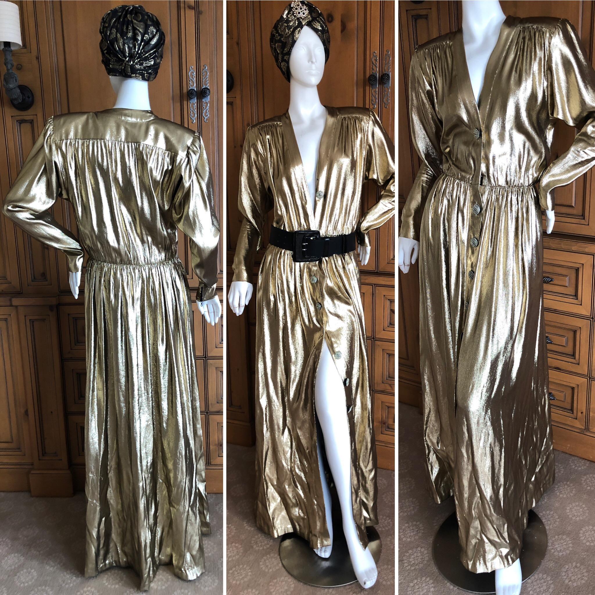 Yves Saint Laurent Rive Gauche 1979 Metallic Gold Silk Structured Shoulder Evening Dress .
Large crystal buttons down the front, this opens all the way, so can reveal more , or less skin.
Truly magnificent, in excellent condition.
Marked size 44,