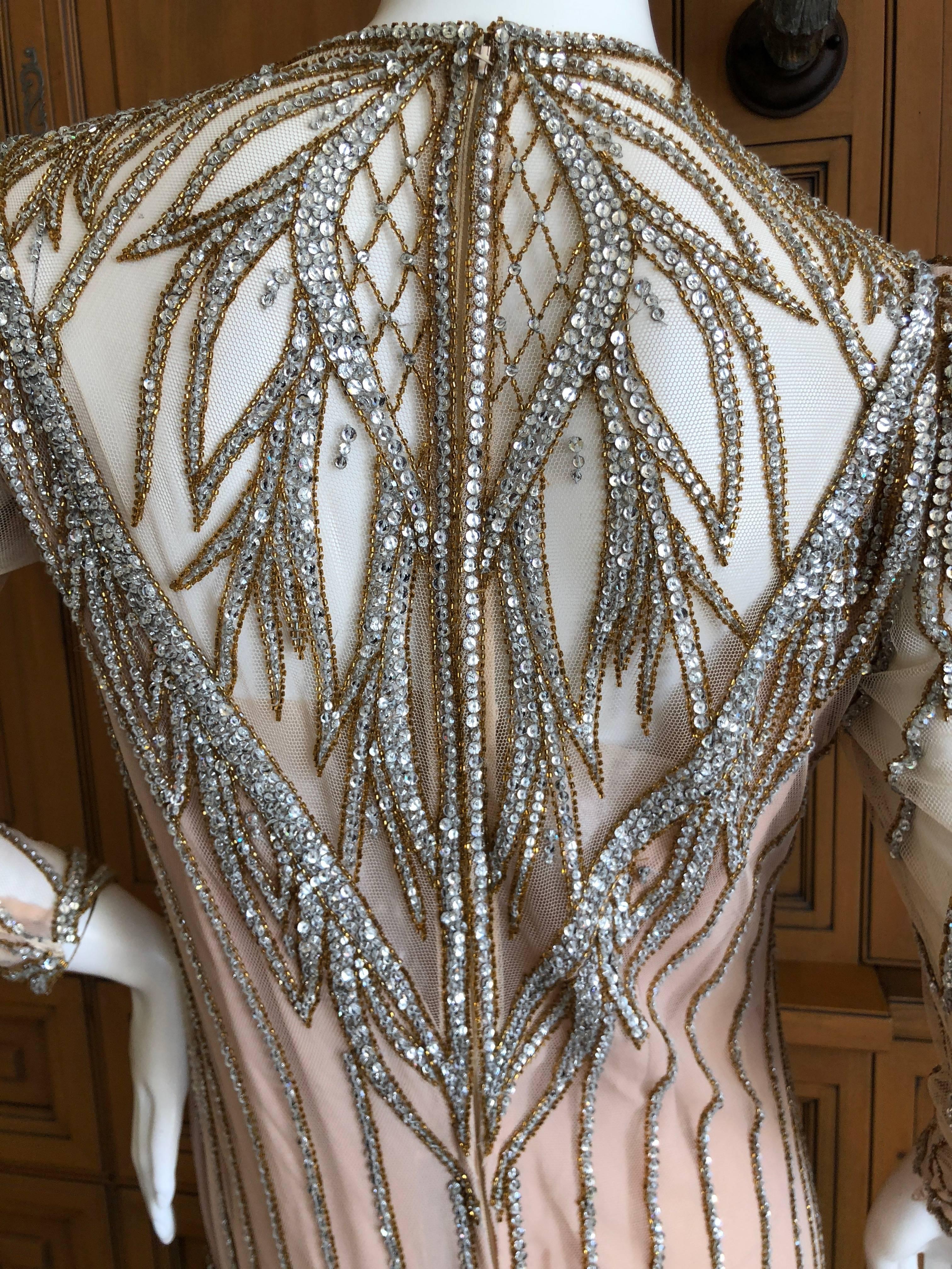 Bob Mackie Nieman Marcus 1980's Crystal Beaded Sheer Evening Dress
Ivory with silver and gold accents, with clear crystals
Uneven hemline, longer in the back, with fringe bead details.
So much prettier than the photos, please use zoom feature to see