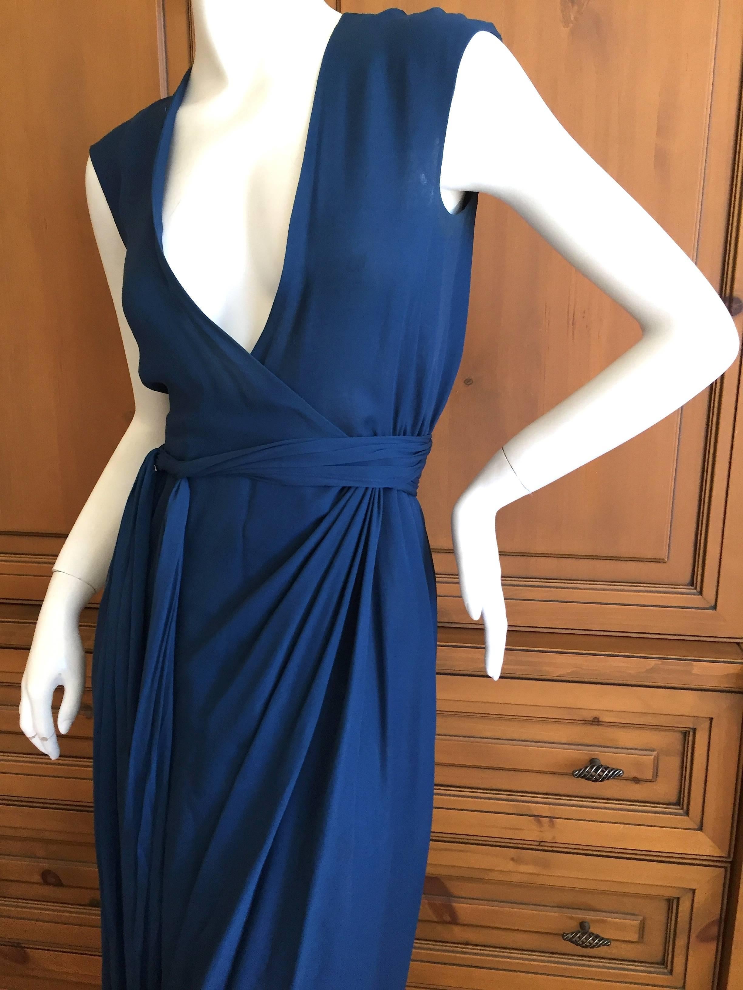 Wonderful 1970's Navy blue wrap dress from Halston.
Deceptively simple, with delicate draped details flowing from the waist.
The genius of Halston was his ability to render such sublime simplicity with his fabrics. Simply chic, Simply sexy, Pure