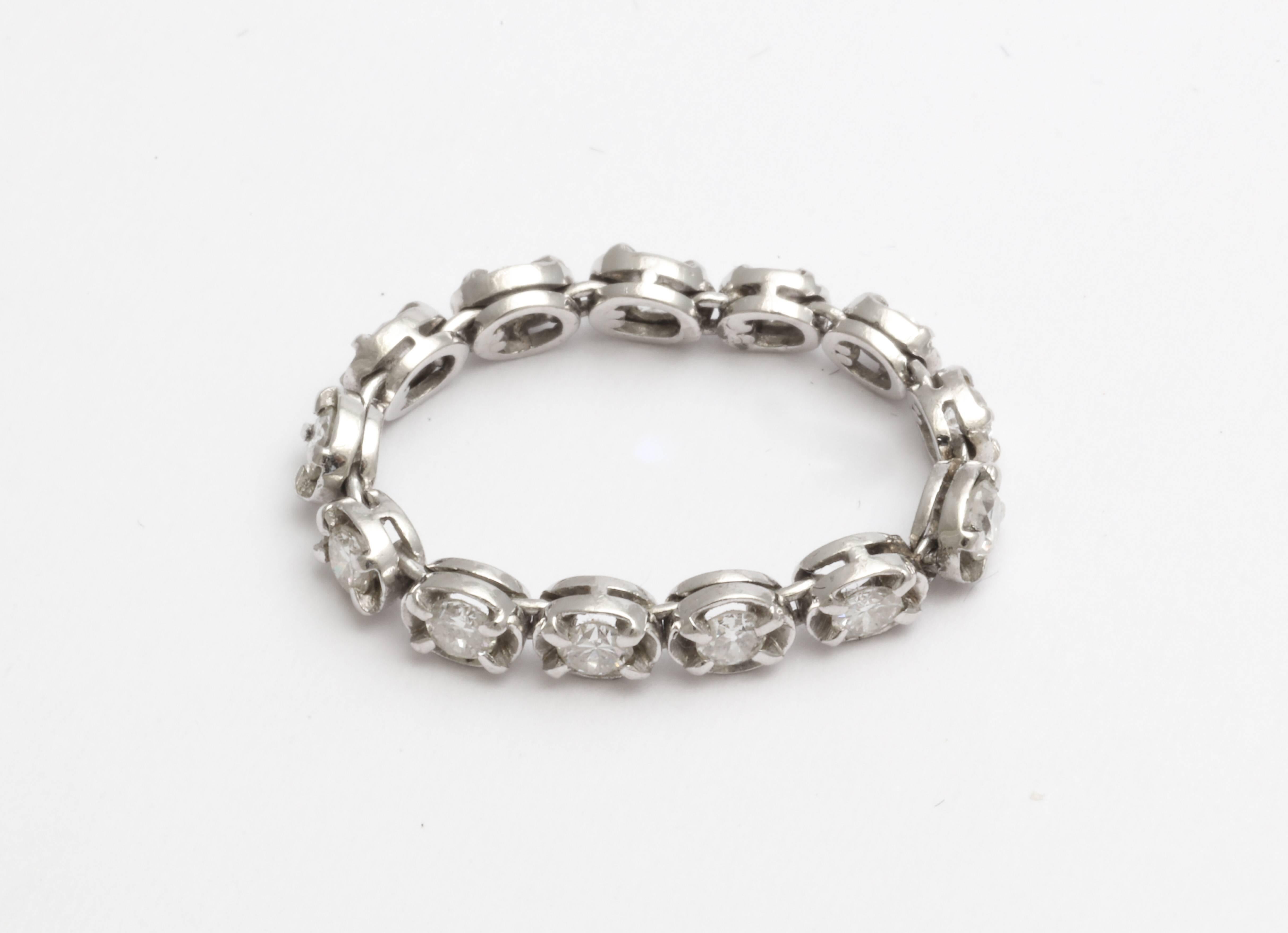A beautiful vintage flexible eternity band with  very good quality diamonds set in platinum.  A vintage flexible band is hard to find.
size 5 1/2 plus.