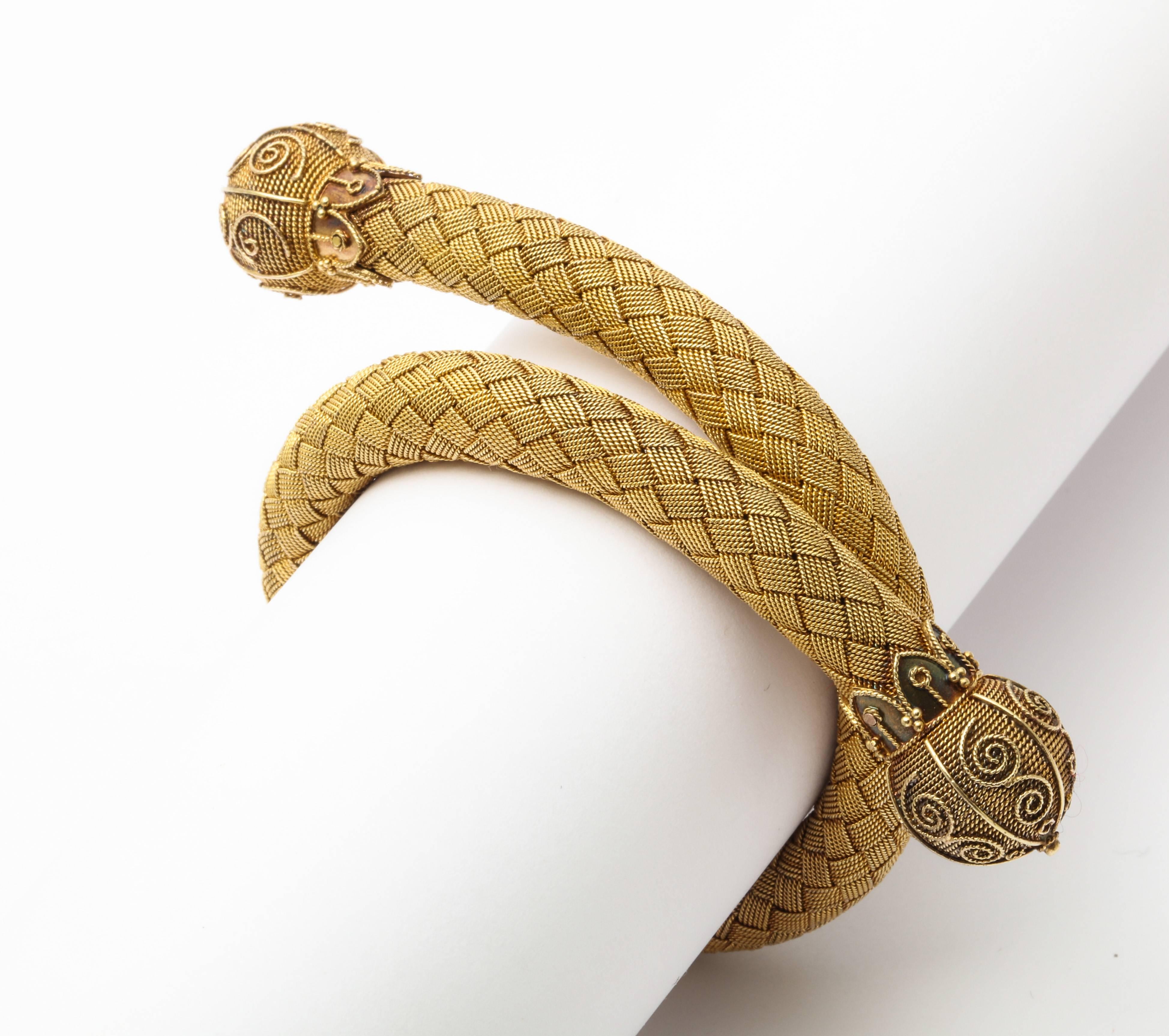 A wonderful woven mesh flexible bracelet with gold filigree ends in snake form 