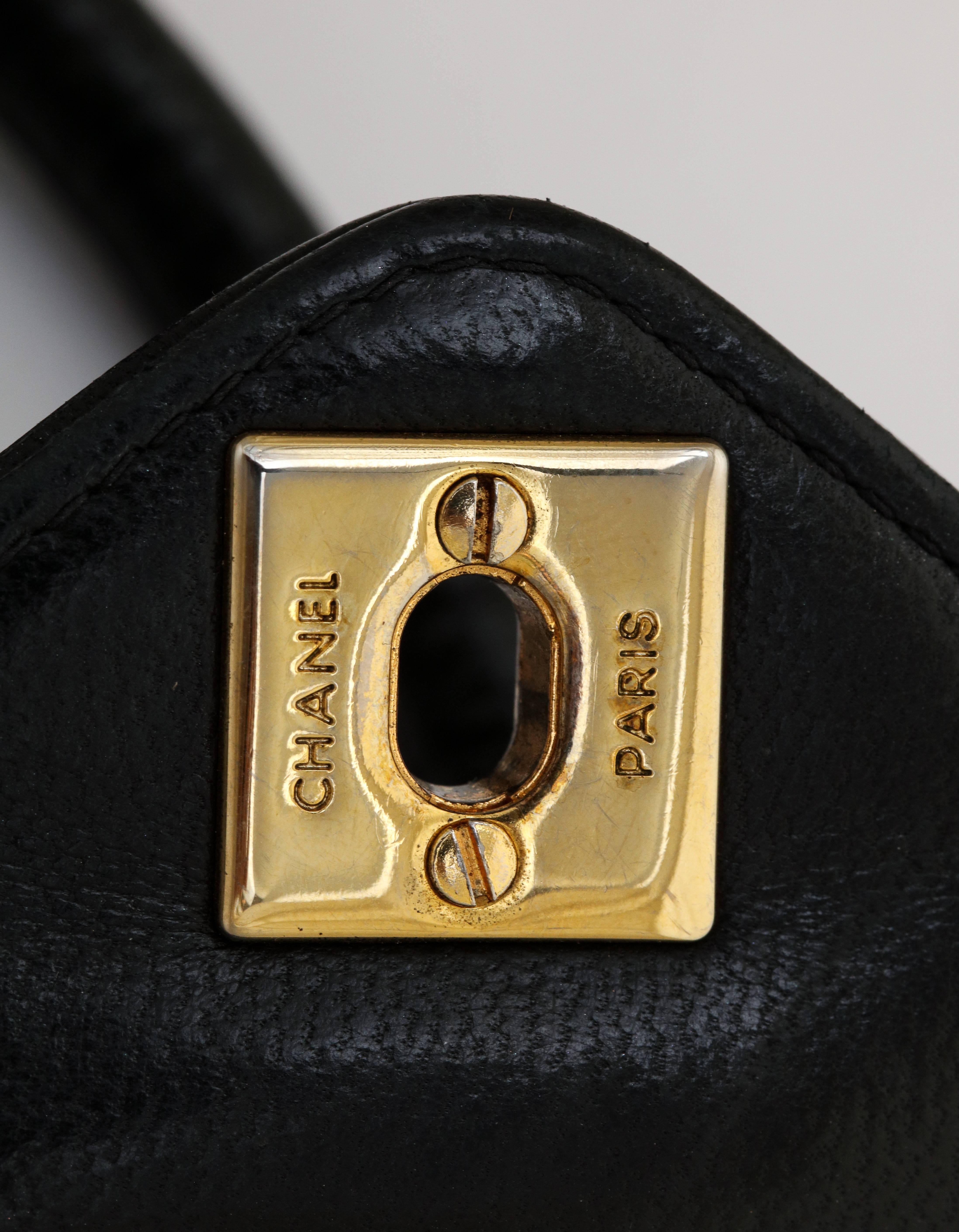 A fabulous black vintage Chanel bag with rolled leather strap 37.5