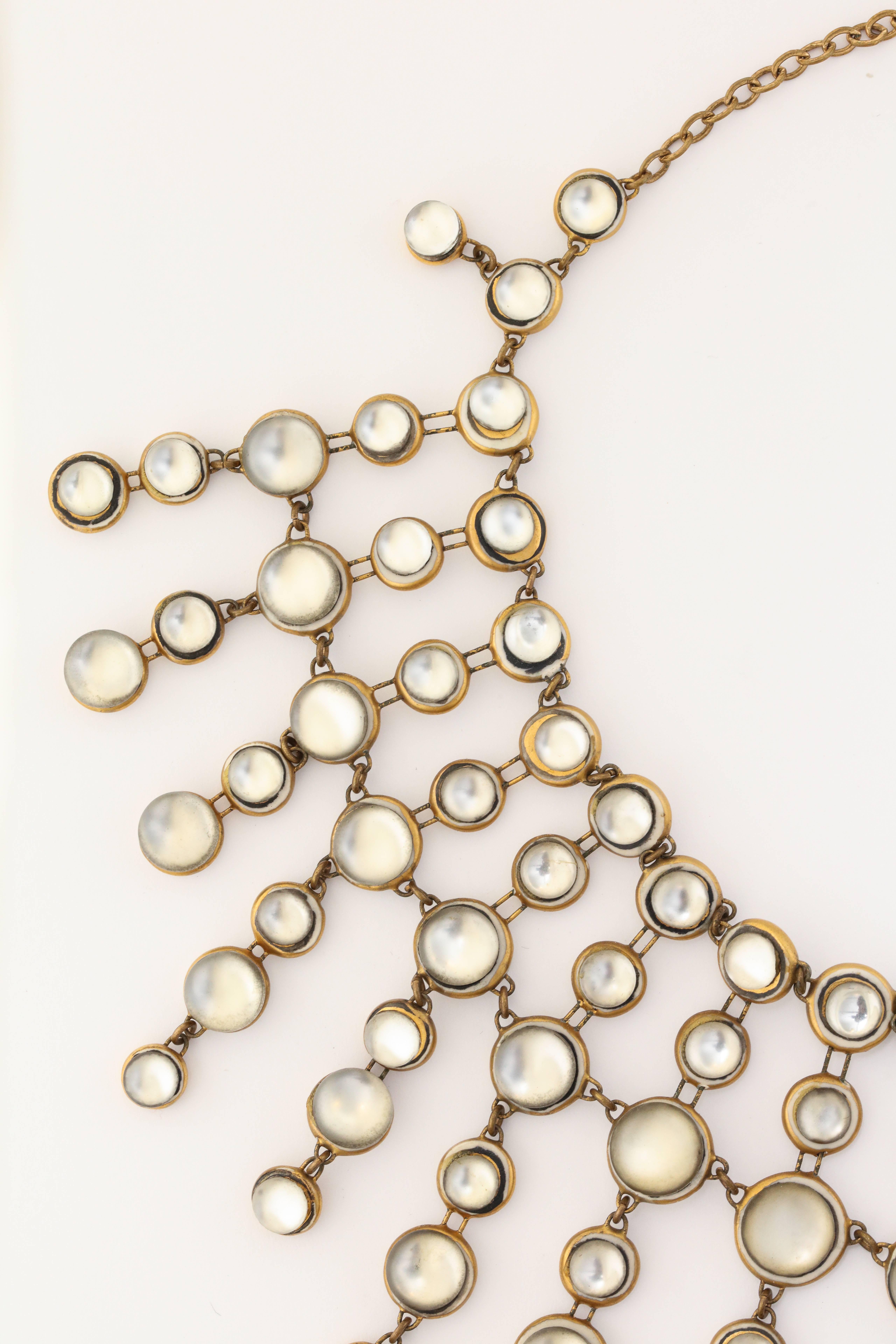 A stunning necklace row by Denise Gatard of glass 'moonstones' backed by ceramic in her signature design 