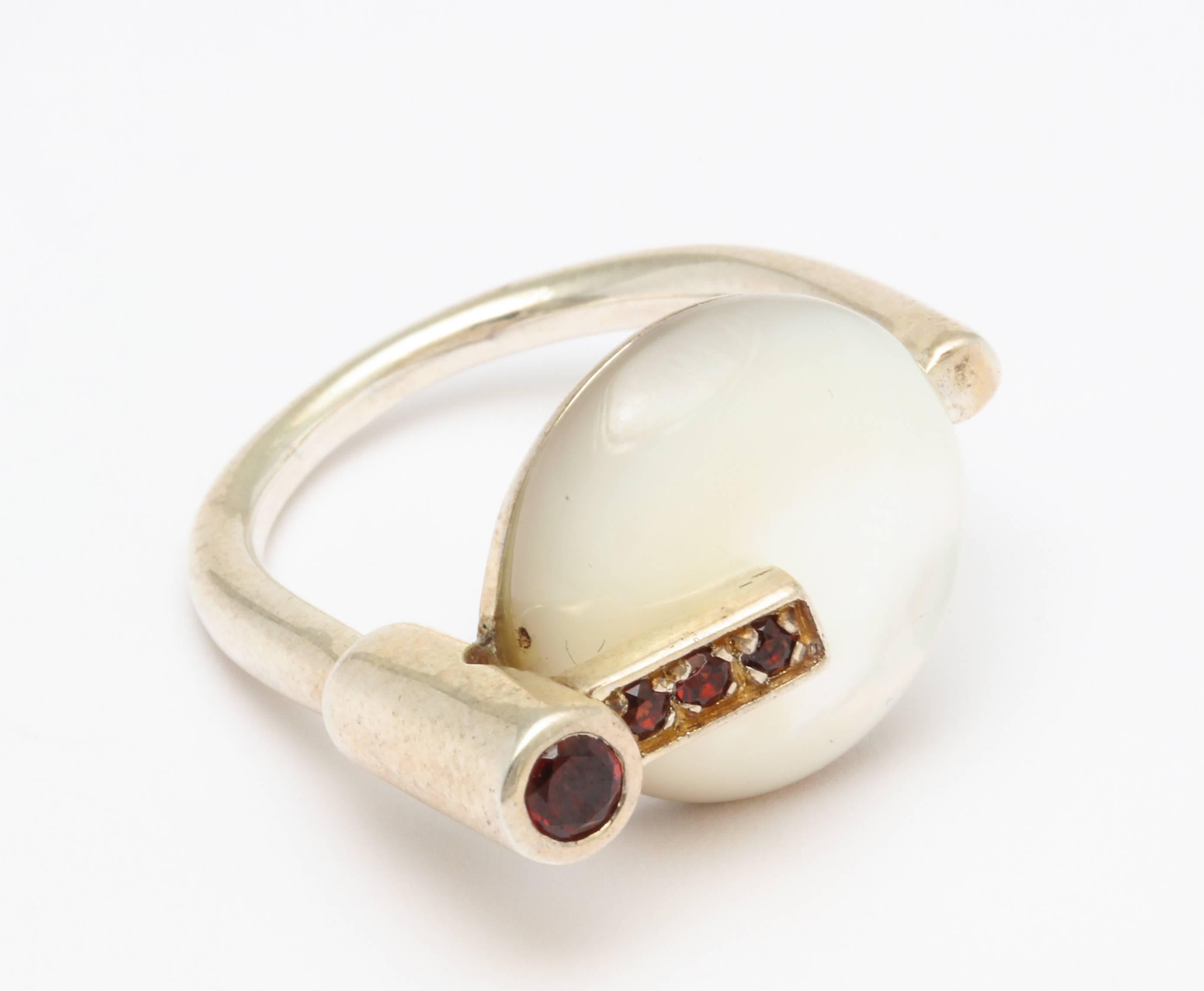 A stunning  modernist ring with garnets and mother of pearl on sterling silver by a German Designer