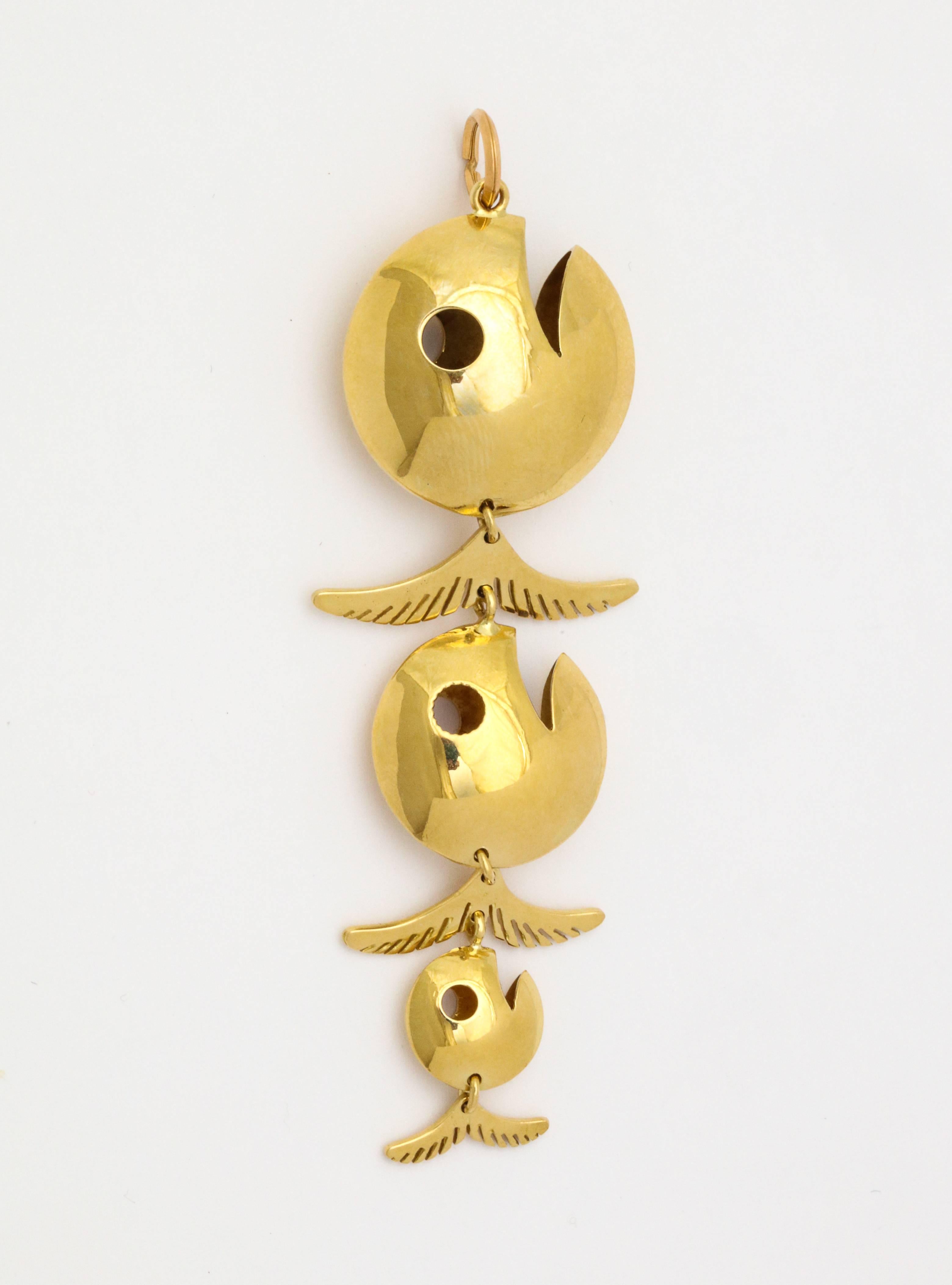 A wonderful series of fish dangle with articulated tails in 18 kt Italian gold.