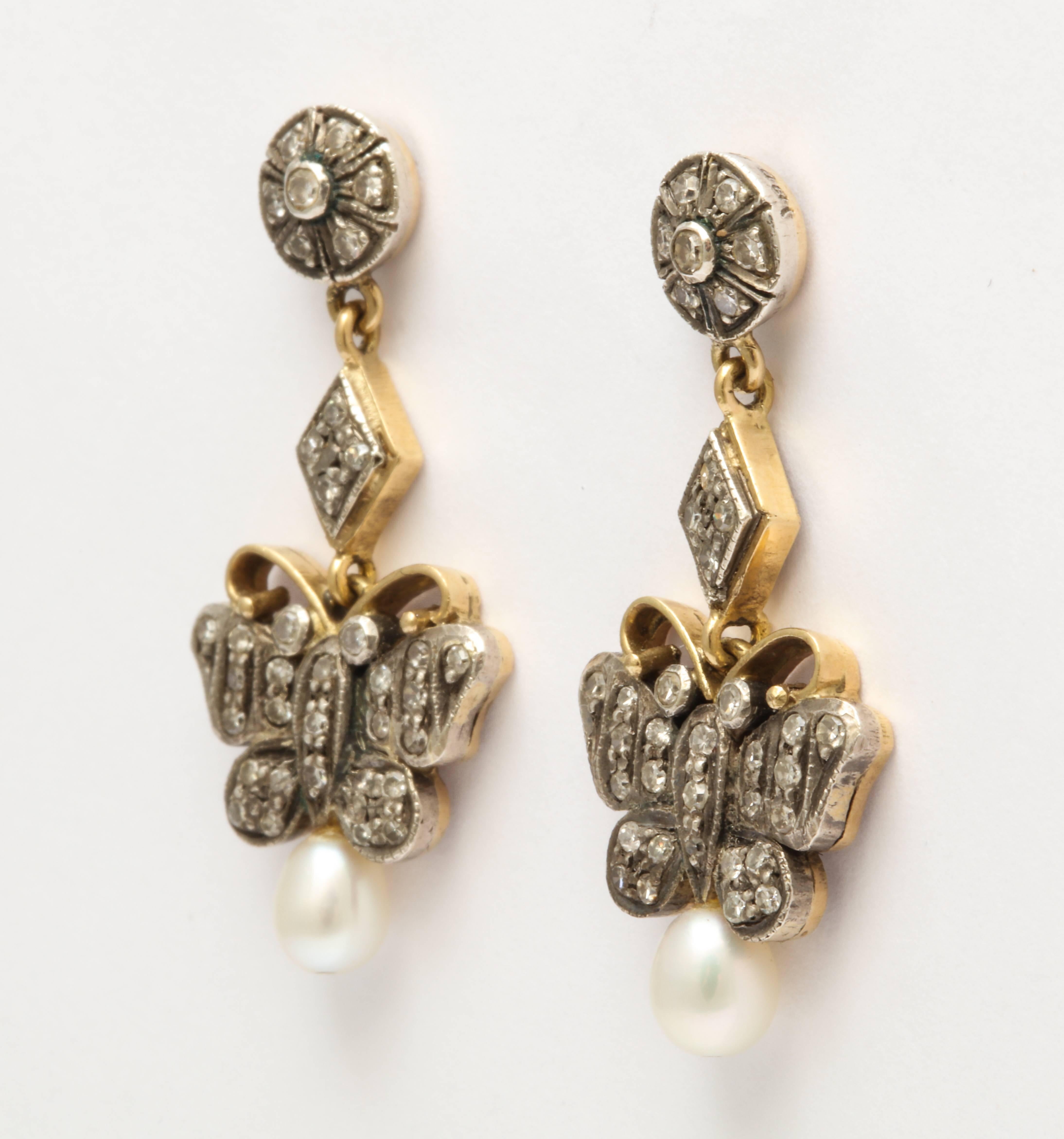 A fabulous pair of Edwardian antique diamond and pearl earrings in a great butterfly form  in 14 kt gold topped with silver.